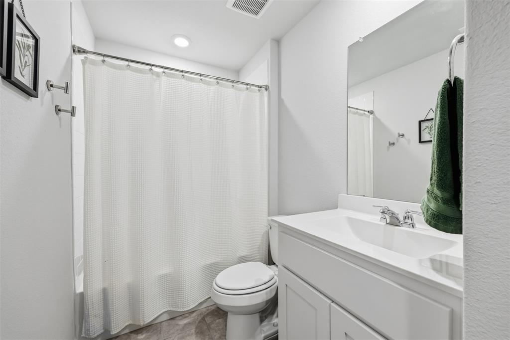 613 Whitecomb Lane Justin, TX 76247 - Photo 7 of 39 a bathroom with a sink toilet and shower