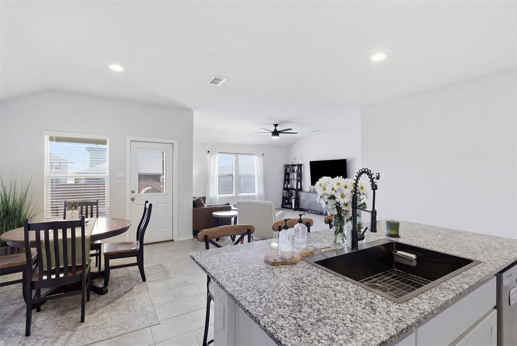613 Whitecomb Lane Justin, TX 76247 - Photo 10 of 39 a kitchen with a dining table and chairs