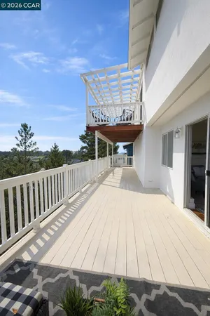a view of balcony with wooden floor and outdoor seating