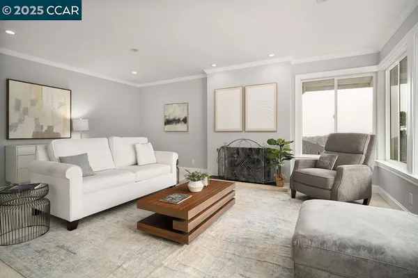 a living room with furniture ceiling fan and a rug