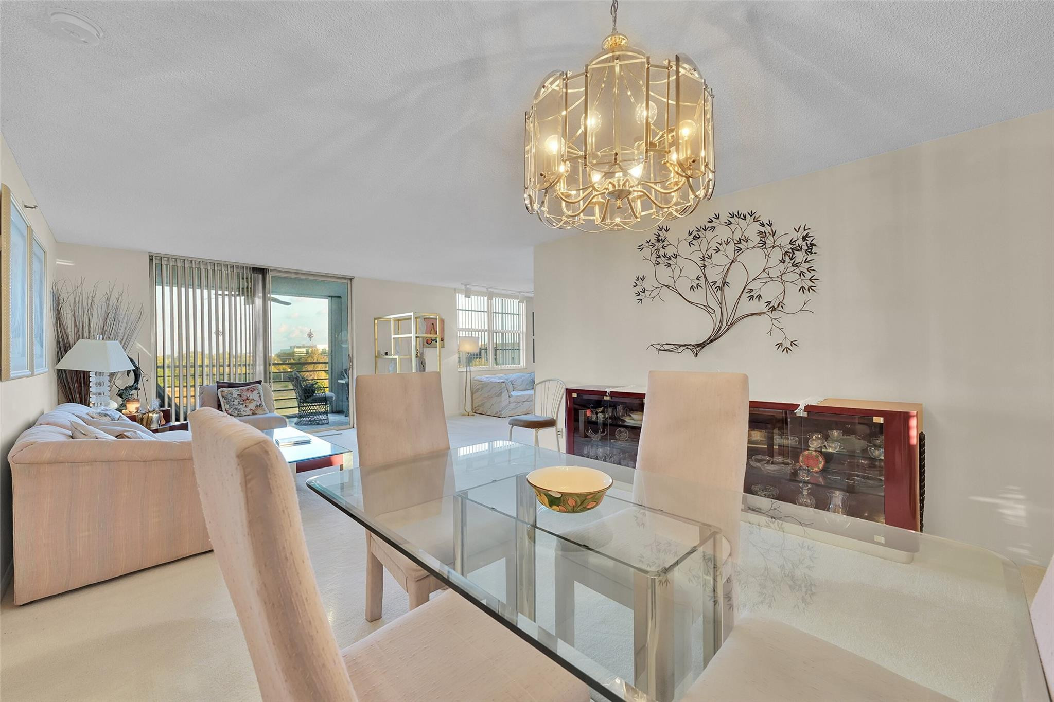 5340 Northwest 2nd Avenue, Unit PH26 Boca Raton, FL 33487 - Photo 18 of 53 a living room with furniture and chandelier