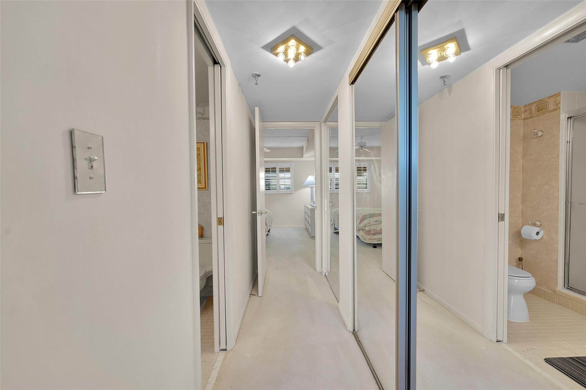 5340 Northwest 2nd Avenue, Unit PH26 Boca Raton, FL 33487 - Photo 24 of 53 a view of a hallway with wooden floor and a bathroom