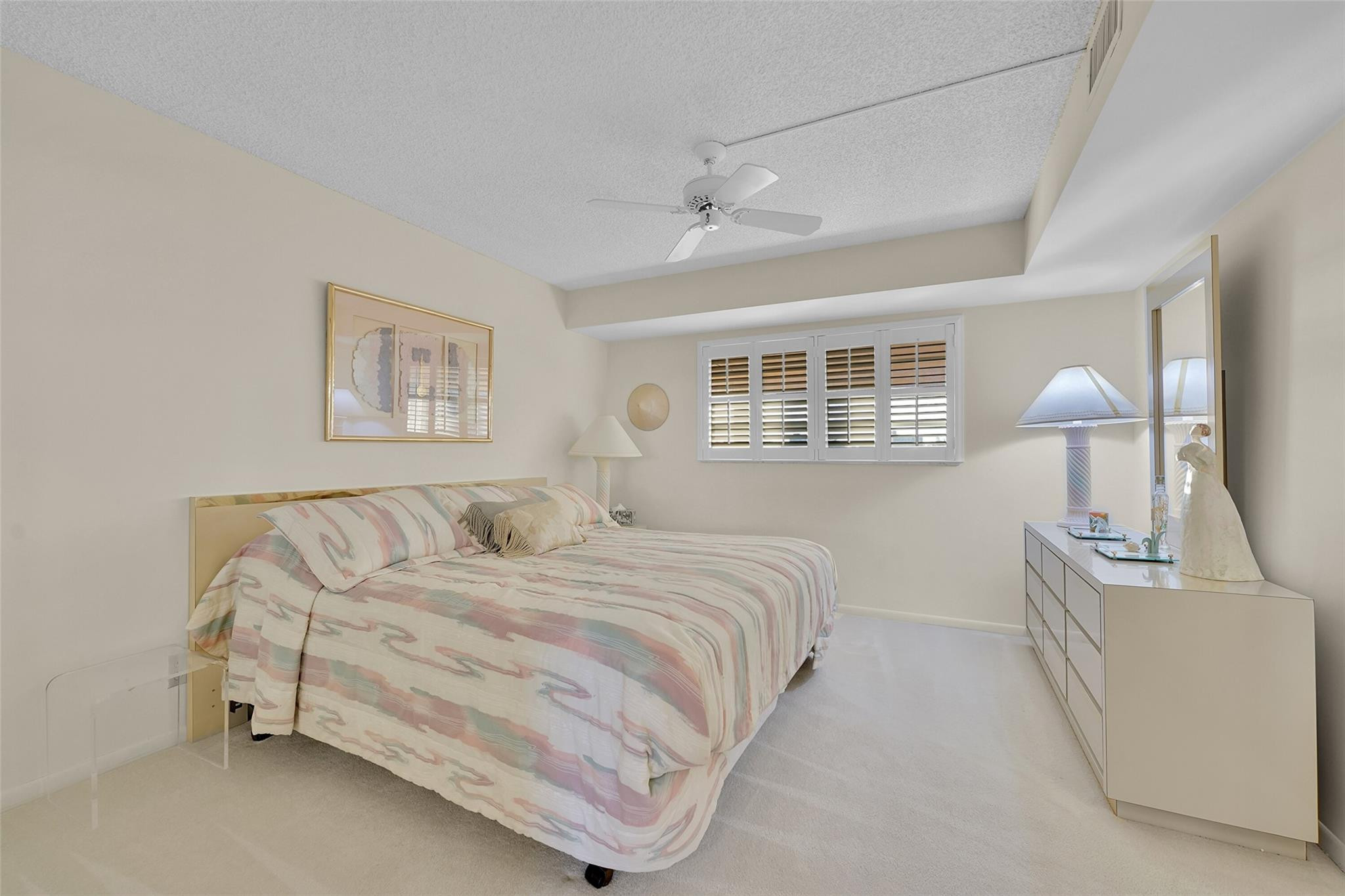 5340 Northwest 2nd Avenue, Unit PH26 Boca Raton, FL 33487 - Photo 25 of 53 a bedroom with a bed and a chandelier