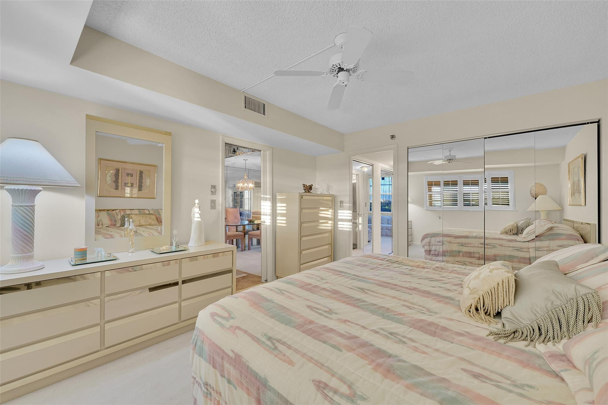 5340 Northwest 2nd Avenue, Unit PH26 Boca Raton, FL 33487 - Photo 27 of 53 a large bedroom with a bed and a large mirror