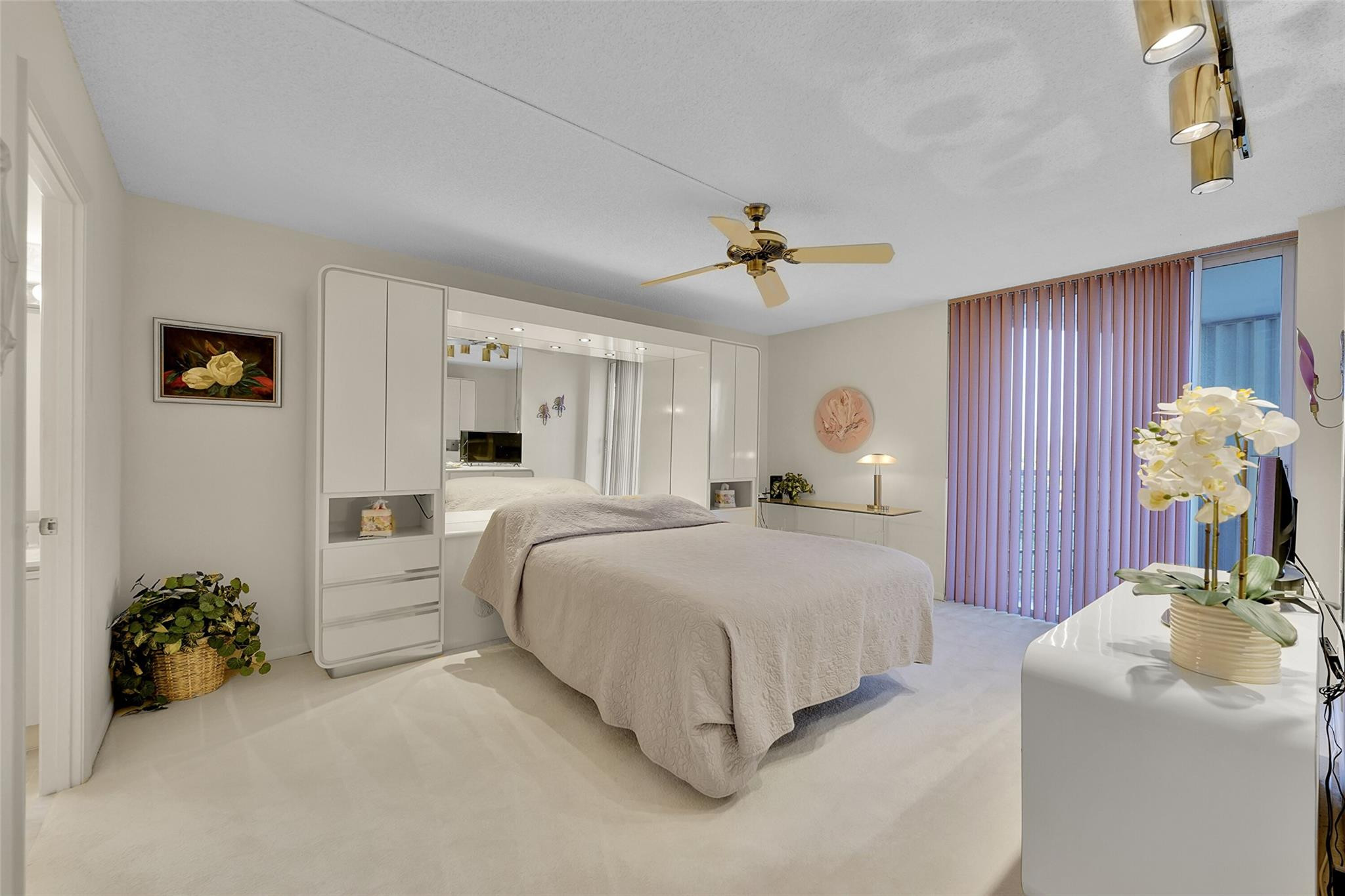 5340 Northwest 2nd Avenue, Unit PH26 Boca Raton, FL 33487 - Photo 29 of 53 a bedroom with bed and a chandelier