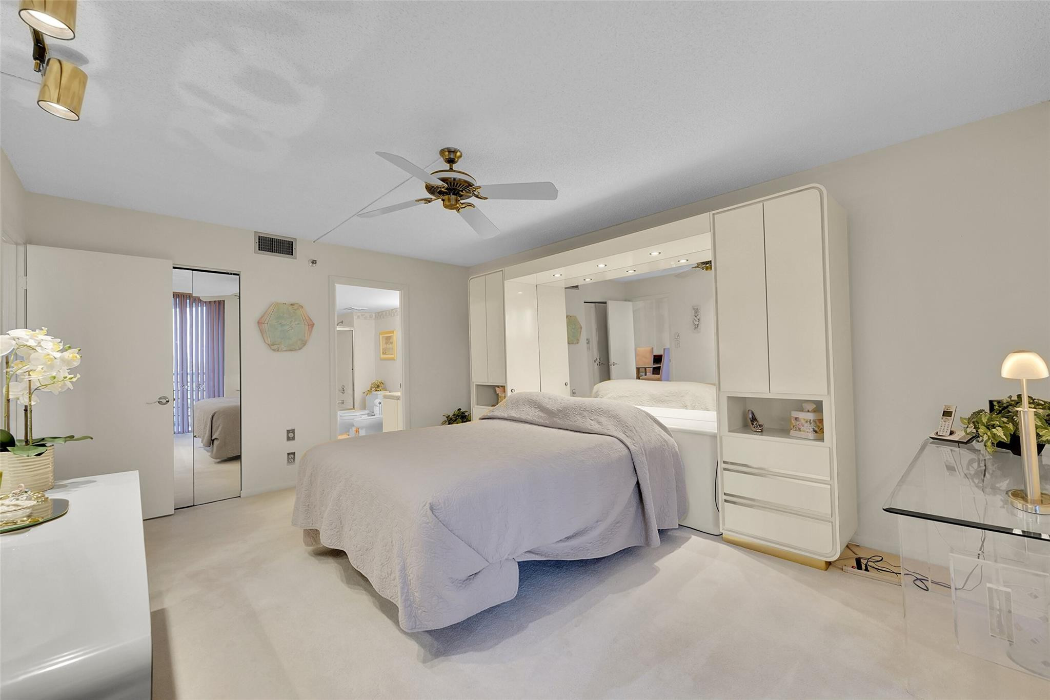 5340 Northwest 2nd Avenue, Unit PH26 Boca Raton, FL 33487 - Photo 30 of 53 a bedroom with a bed and a chandelier