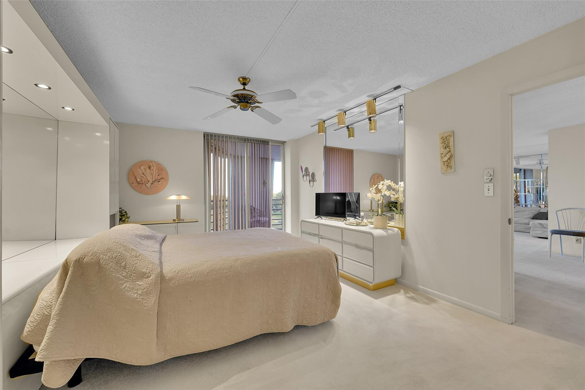 5340 Northwest 2nd Avenue, Unit PH26 Boca Raton, FL 33487 - Photo 33 of 53 a bedroom with a large bed and a chandelier
