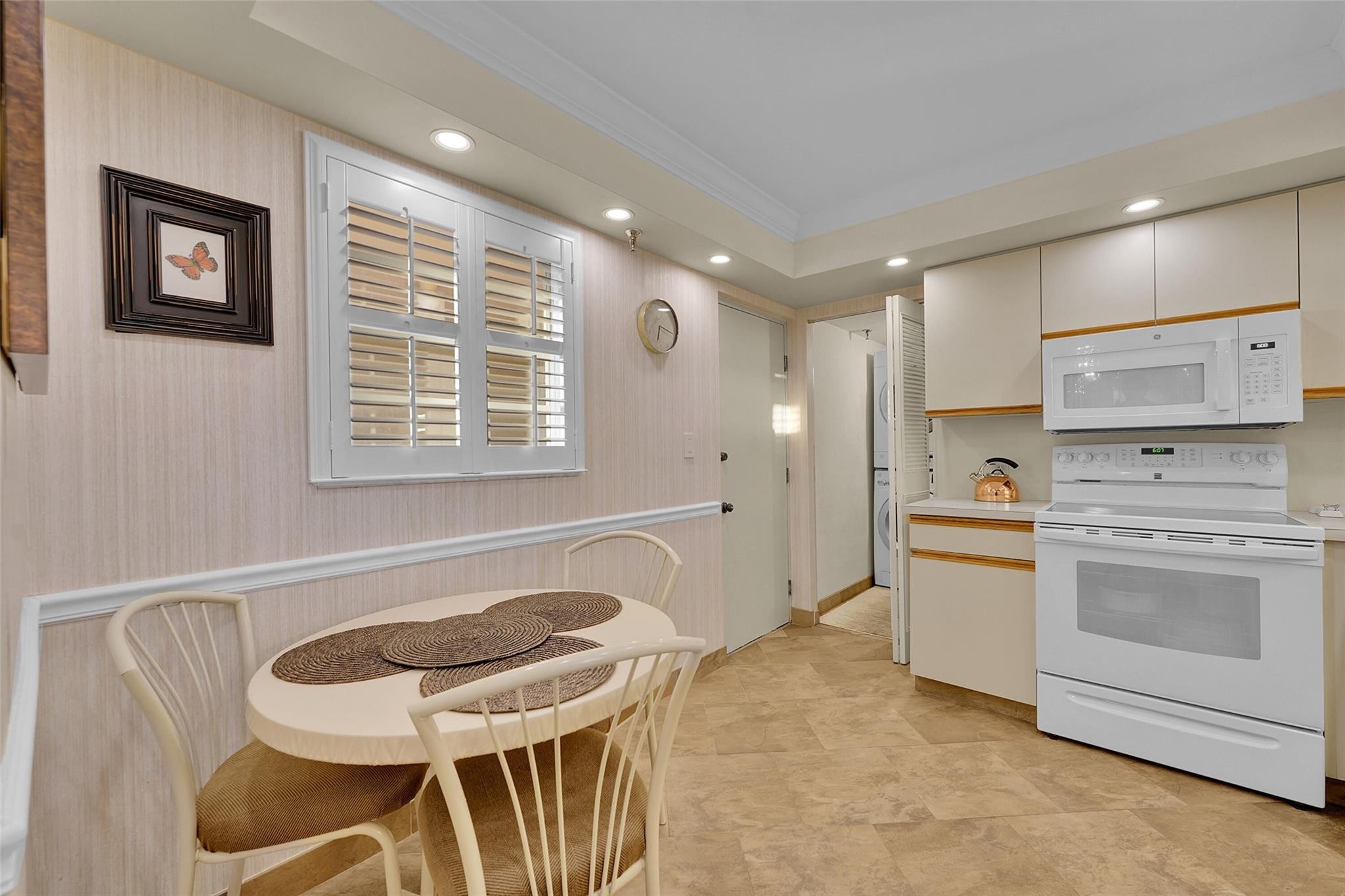 5340 Northwest 2nd Avenue, Unit PH26 Boca Raton, FL 33487 - Photo 35 of 53 a kitchen with stainless steel appliances granite countertop a stove a sink a dining table and chairs