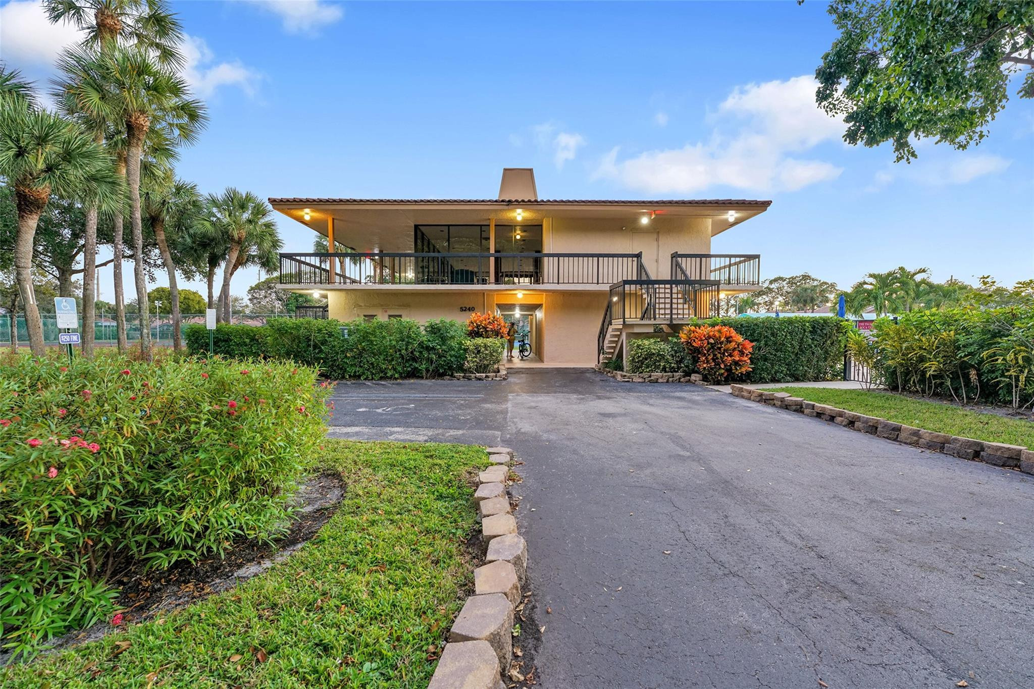 5340 Northwest 2nd Avenue, Unit PH26 Boca Raton, FL 33487 - Photo 43 of 53 a front view of a house with a yard and potted plants