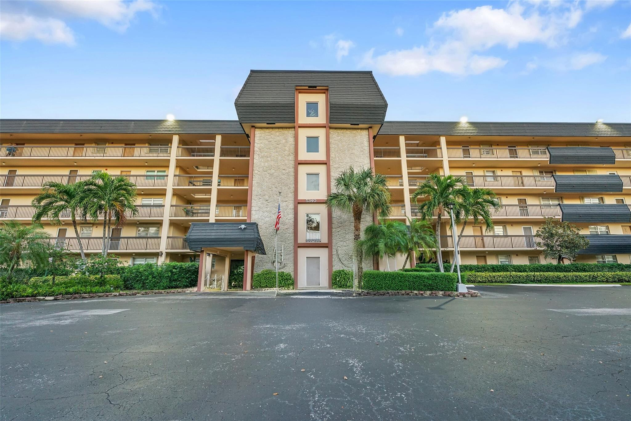 5340 Northwest 2nd Avenue, Unit PH26 Boca Raton, FL 33487 - Photo 8 of 53 a front view of a house with a yard