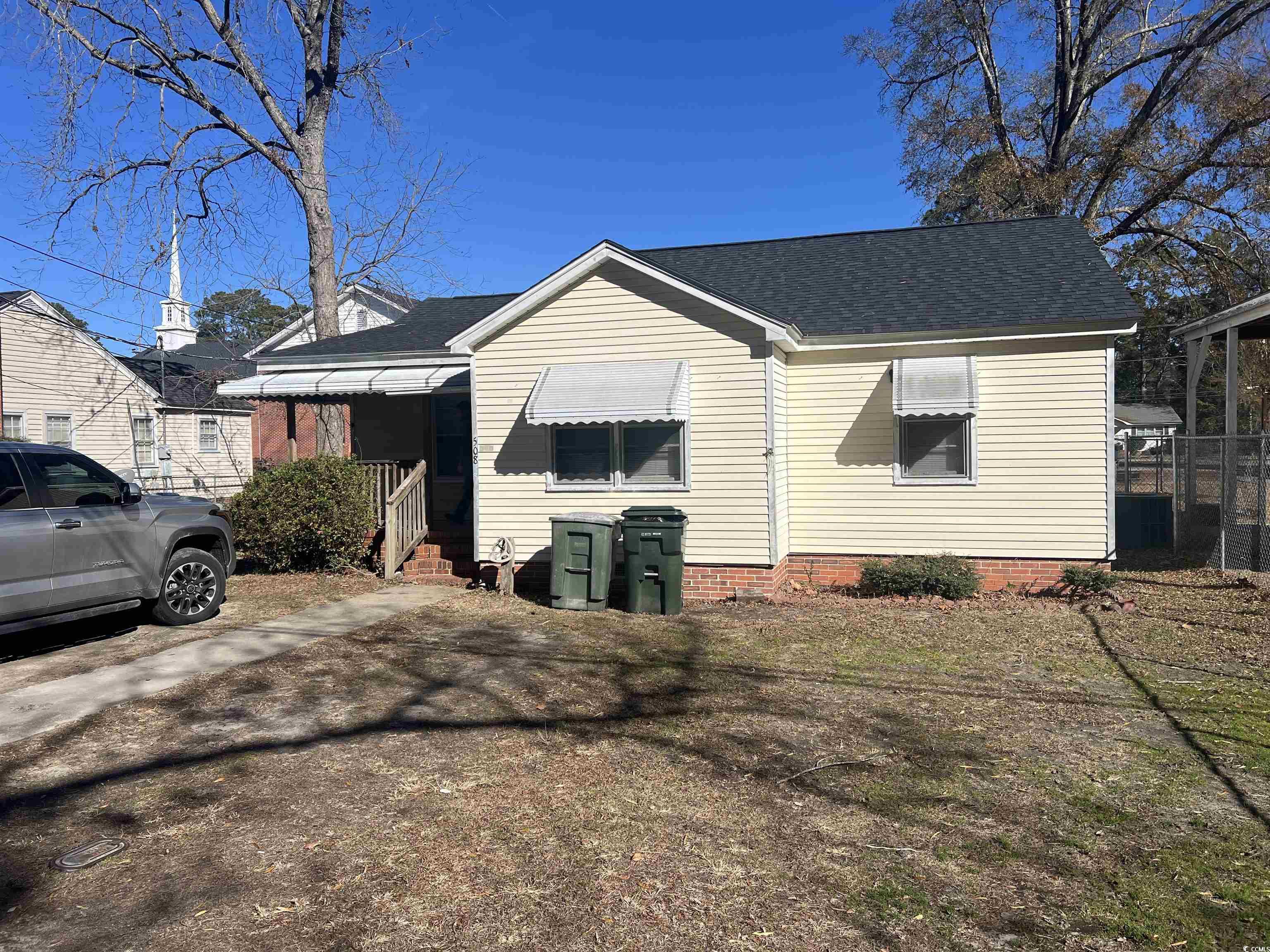 View of side of home featuring roof with shingles