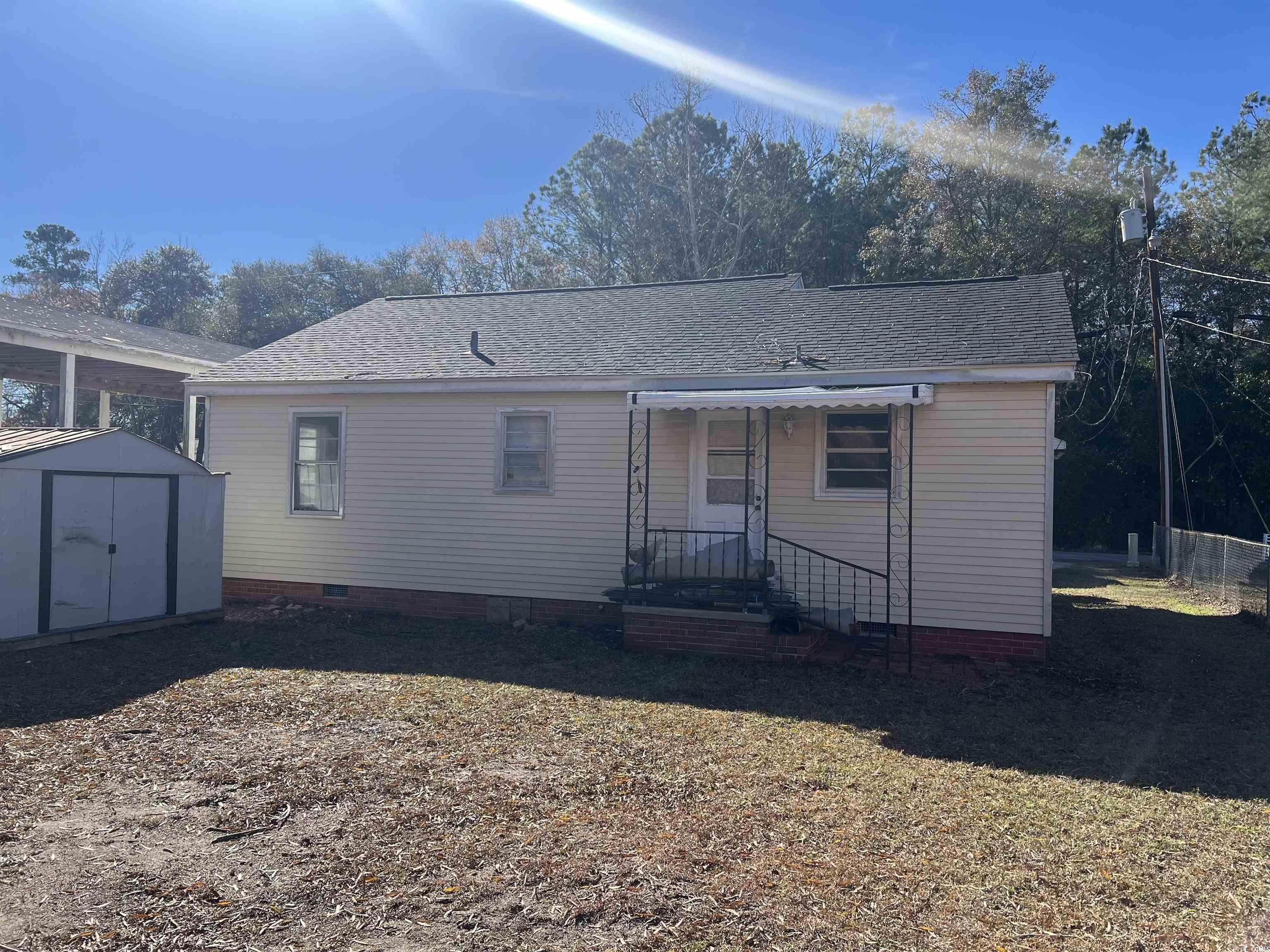508 Sycamore Street Conway, SC 29527 - Photo 11 of 11 Back of house with a shed, roof with shingles, and crawl space
