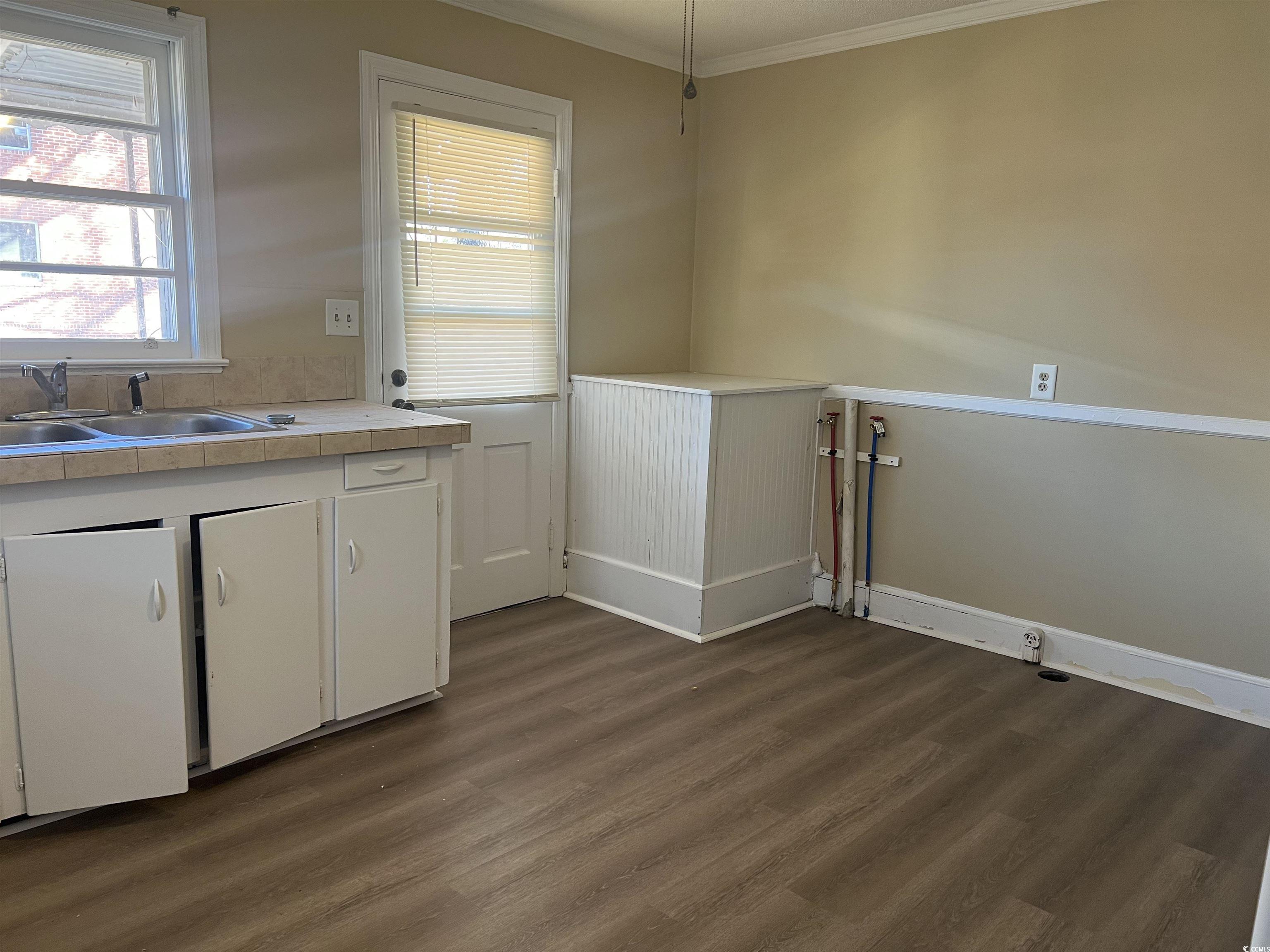 508 Sycamore Street Conway, SC 29527 - Photo 3 of 11 Laundry area with dark wood-style flooring and crown molding