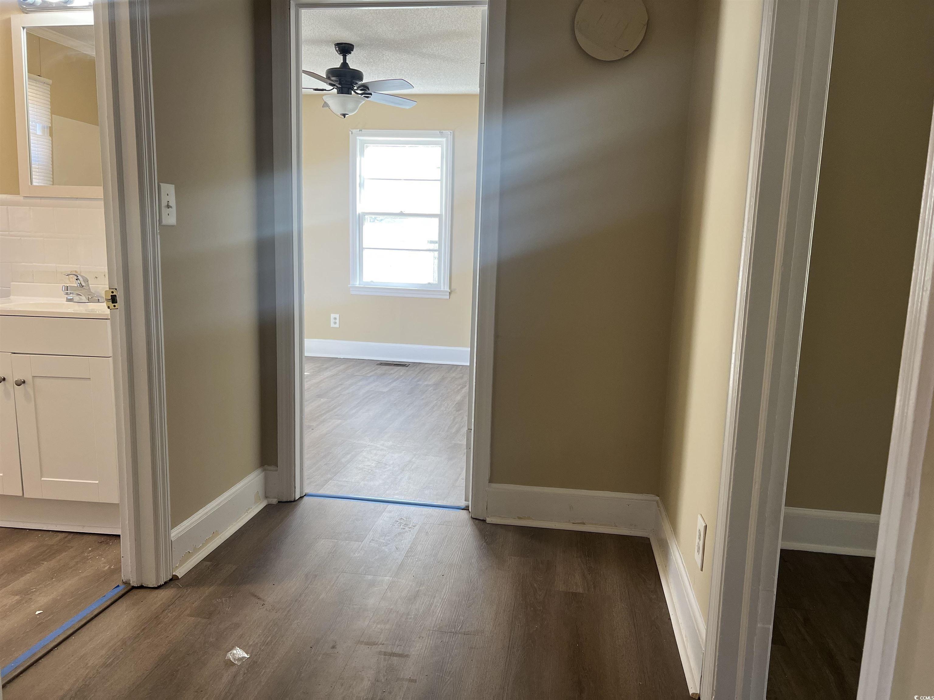 508 Sycamore Street Conway, SC 29527 - Photo 4 of 11 Hallway featuring baseboards and dark wood-style flooring