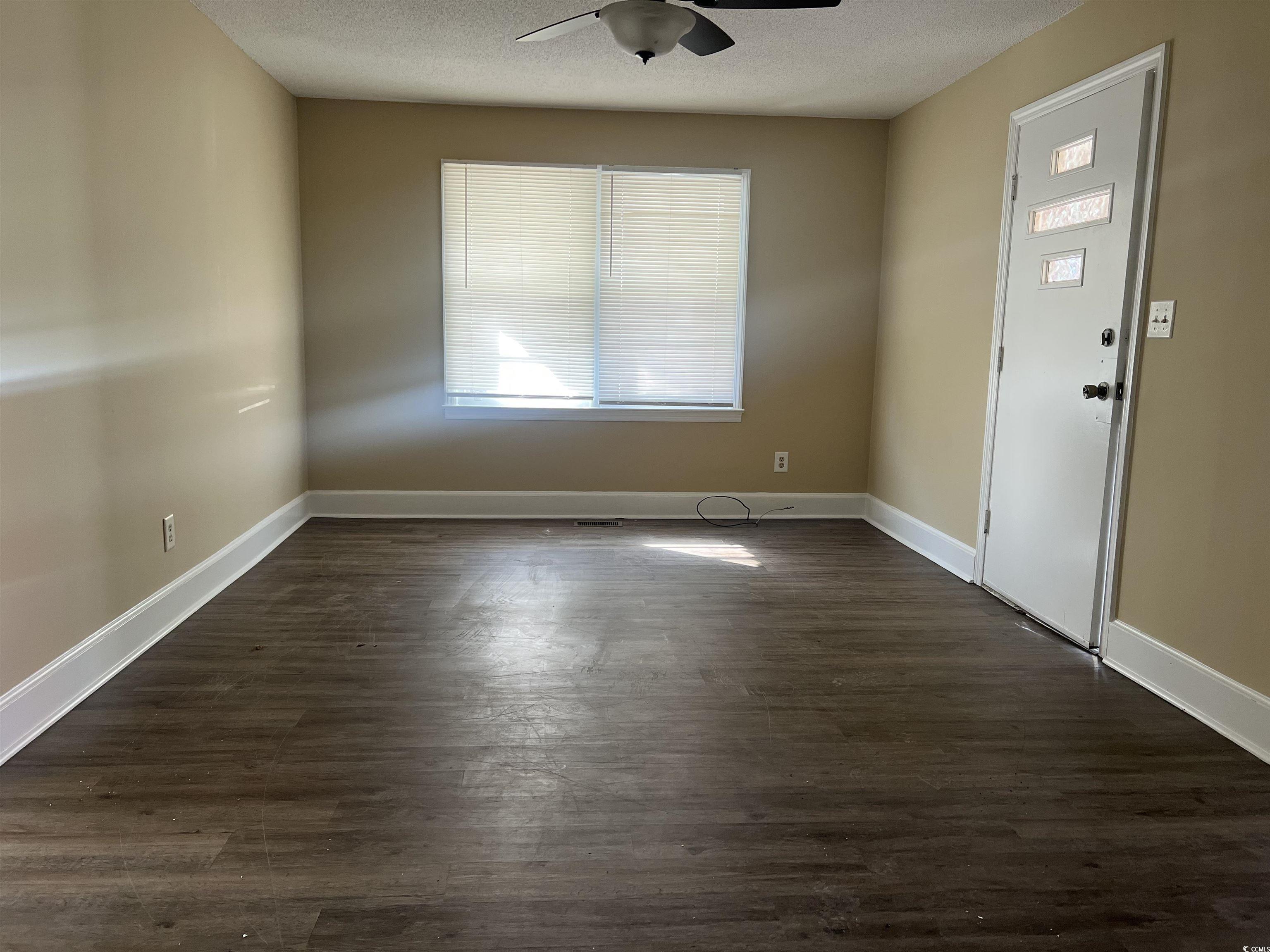 508 Sycamore Street Conway, SC 29527 - Photo 7 of 11 Entrance foyer featuring dark wood-style flooring, a textured ceiling, and a ceiling fan