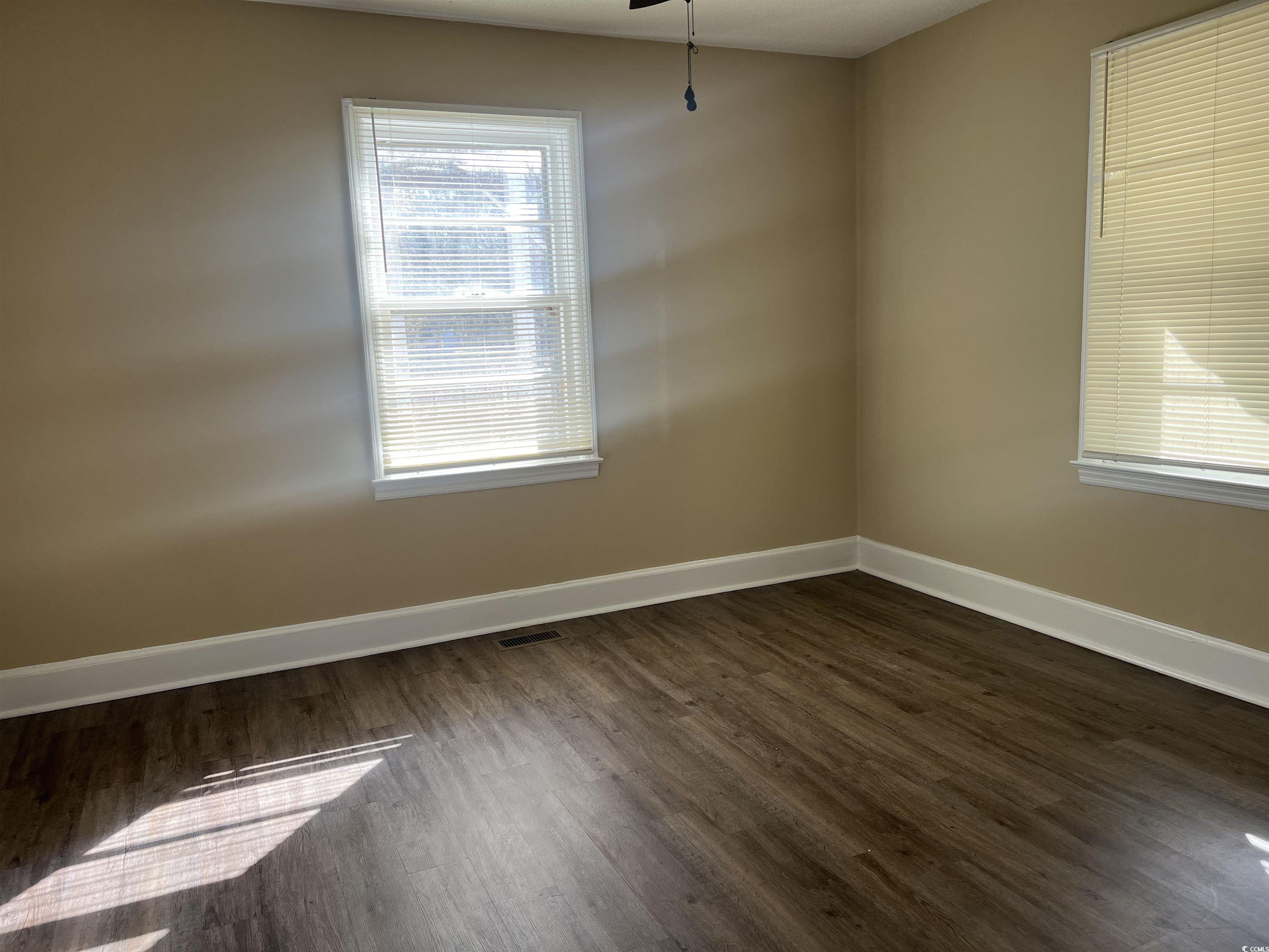 508 Sycamore Street Conway, SC 29527 - Photo 9 of 11 Spare room featuring baseboards and dark wood finished floors