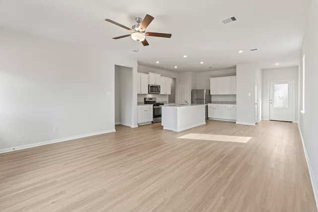 a kitchen with a sink stove top oven and refrigerator