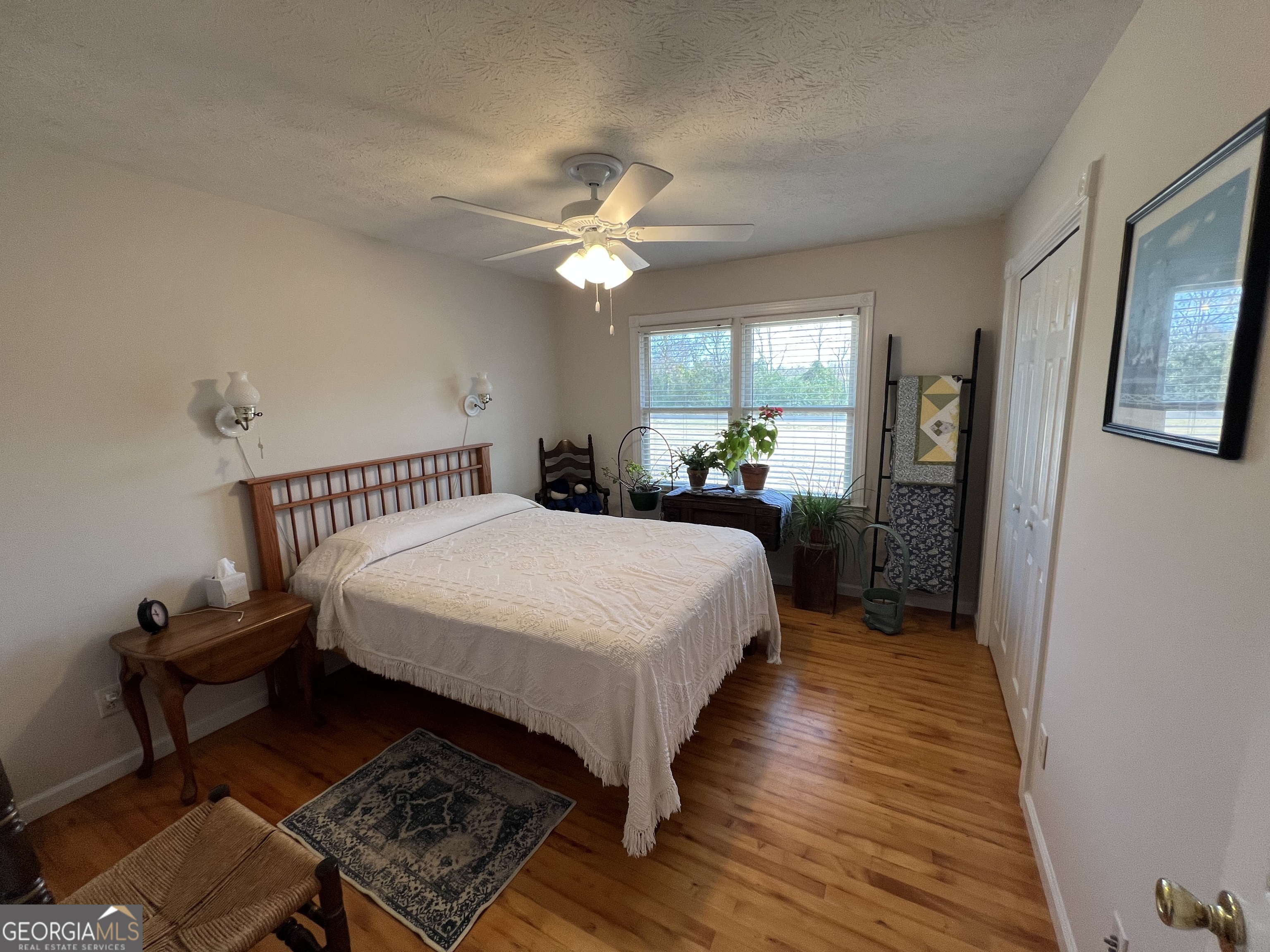 1512 Buckeye Road East Dublin, GA 31027 - Photo 16 of 45 a bed room with a bed and a chandelier