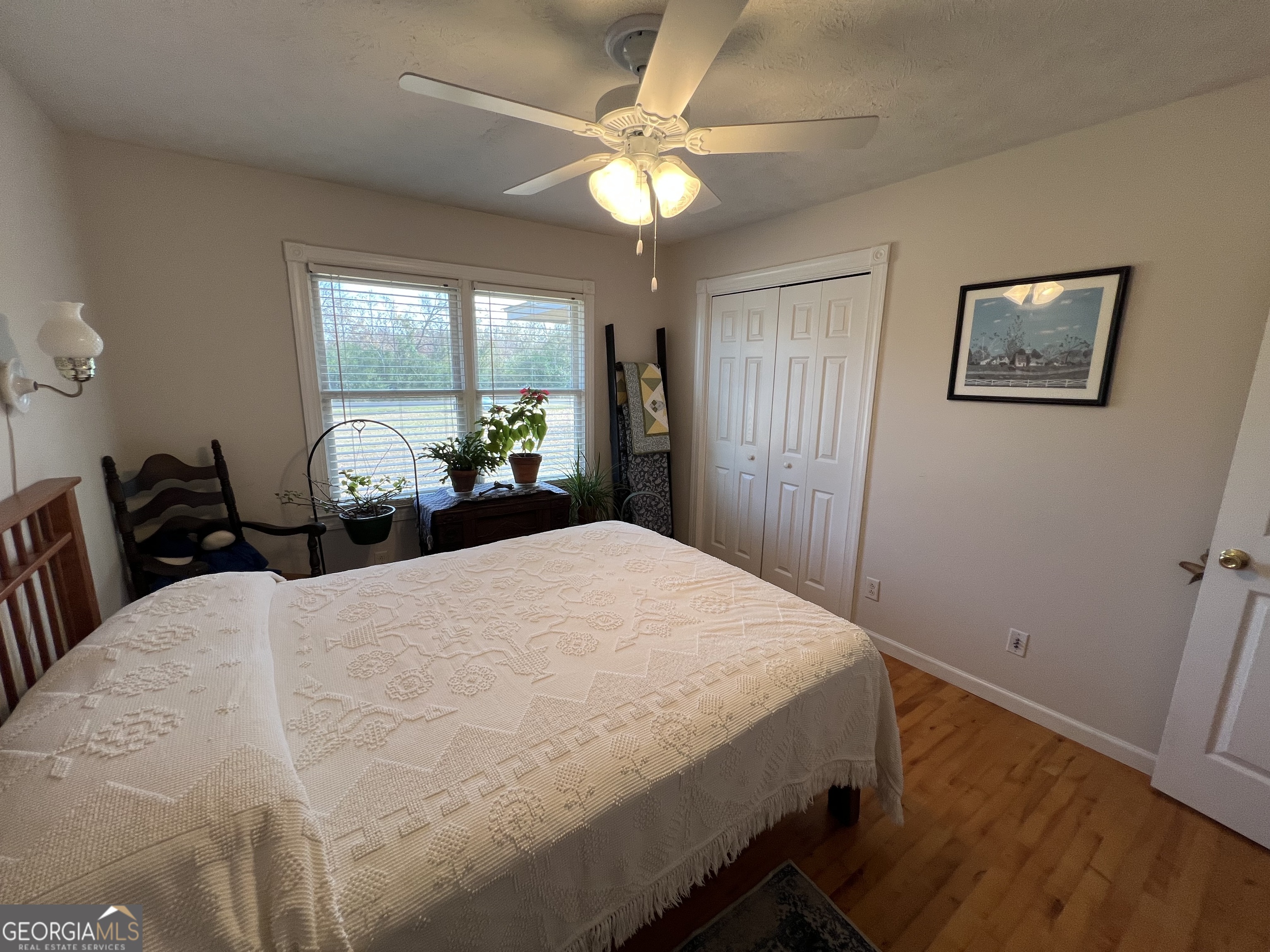 1512 Buckeye Road East Dublin, GA 31027 - Photo 17 of 45 a bedroom with a bed and a chandelier