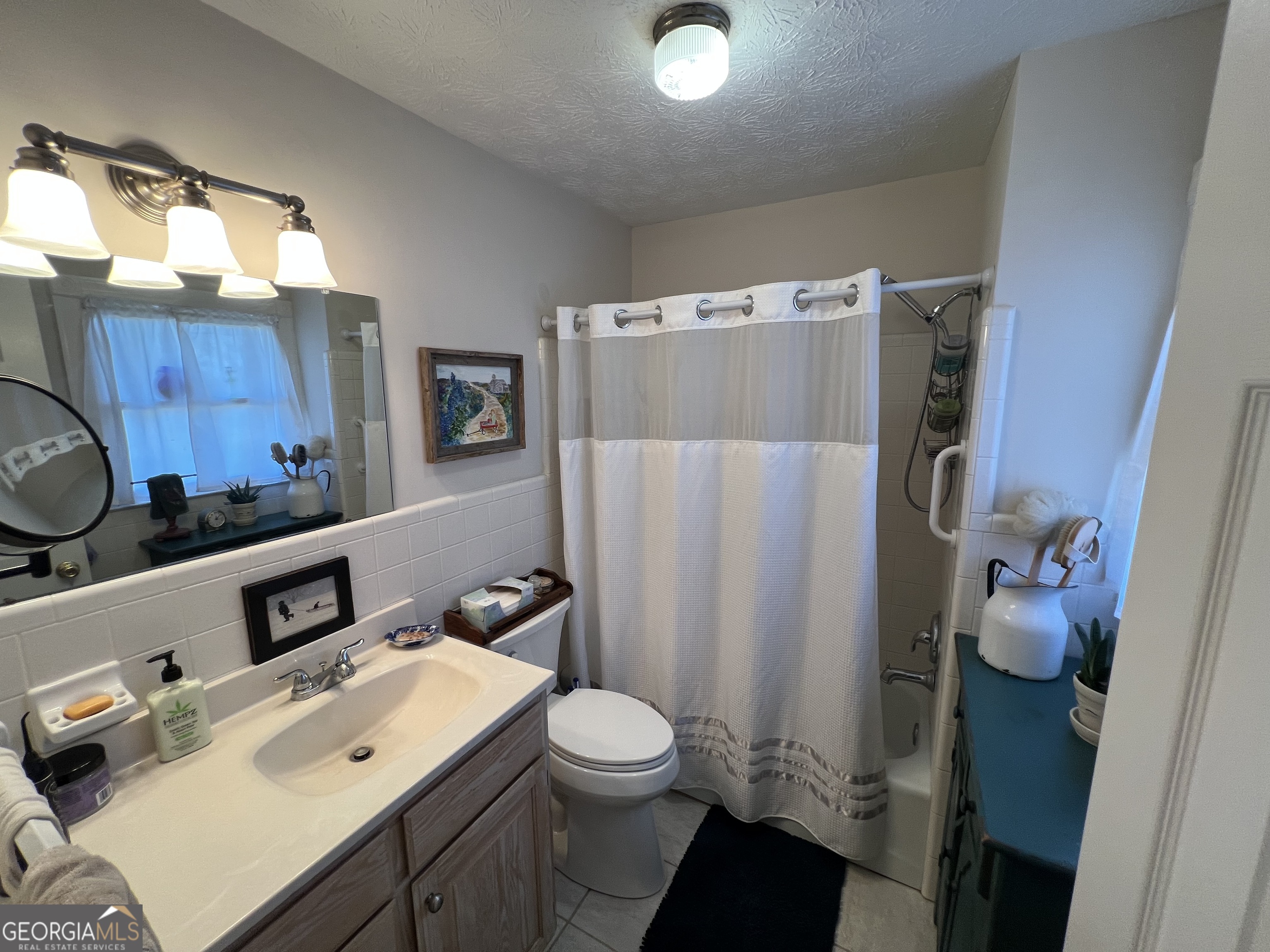 1512 Buckeye Road East Dublin, GA 31027 - Photo 21 of 45 a bathroom with a sink toilet and shower