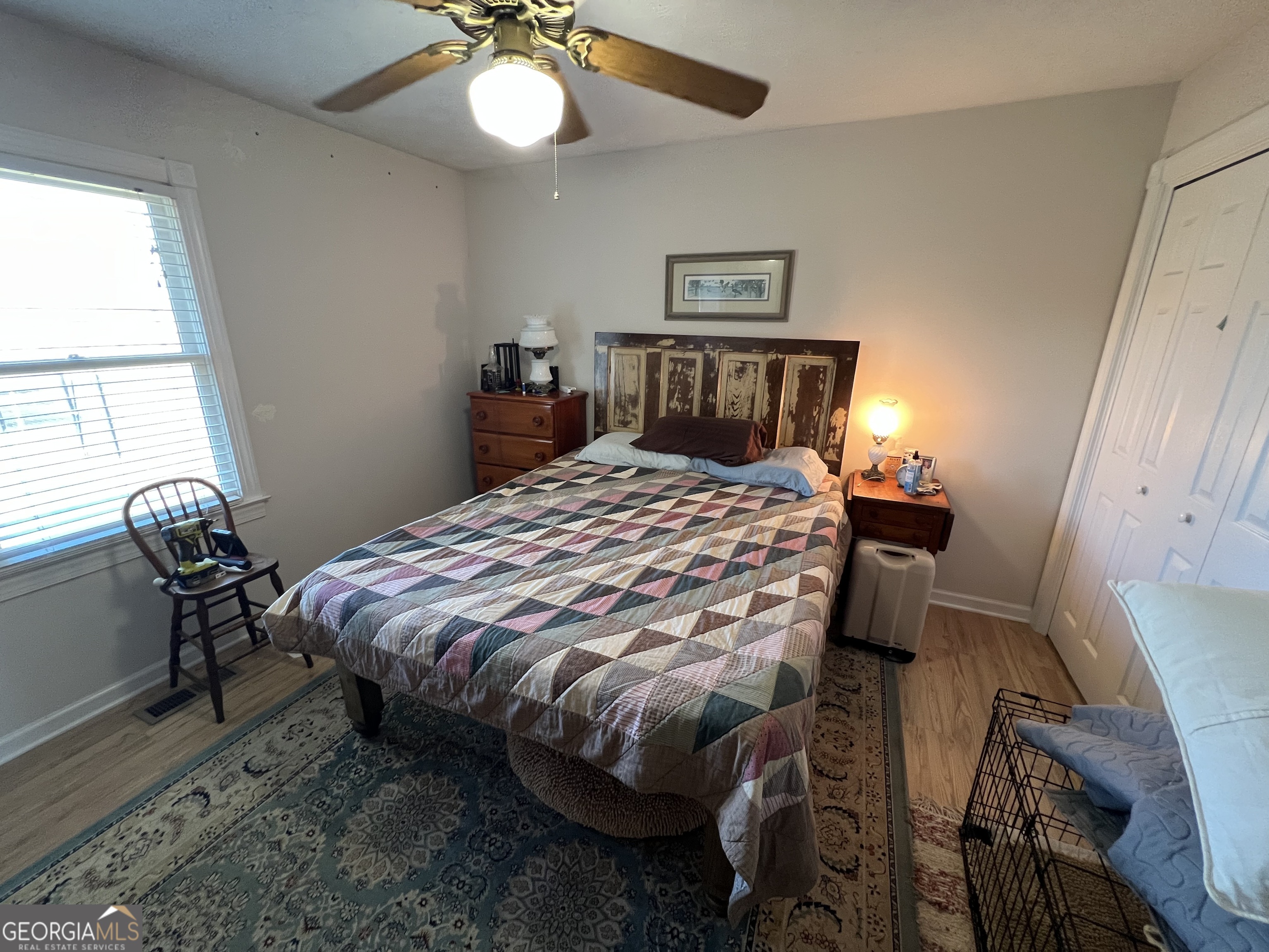 1512 Buckeye Road East Dublin, GA 31027 - Photo 23 of 45 a bedroom with a bed and a chandelier
