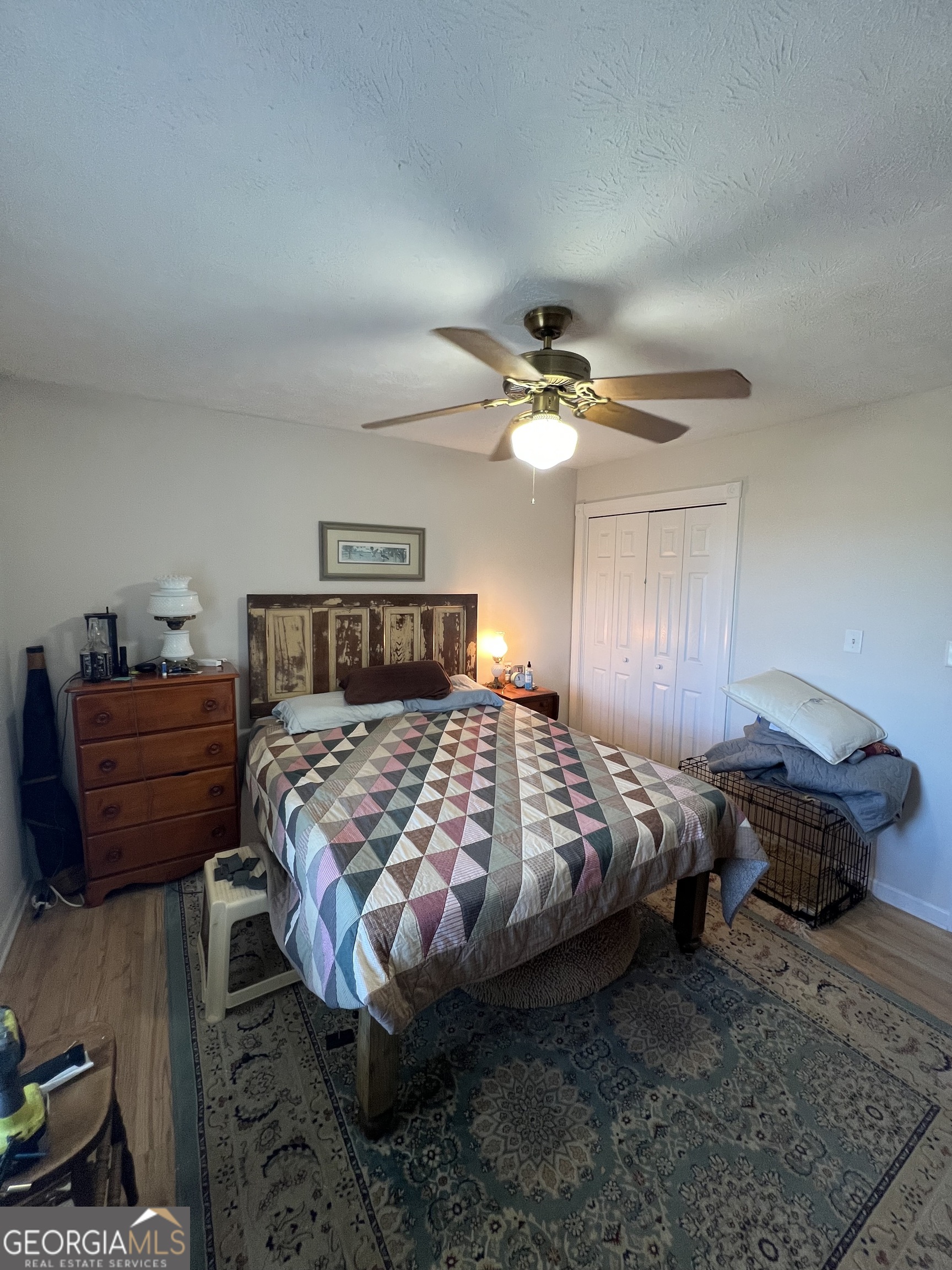 1512 Buckeye Road East Dublin, GA 31027 - Photo 24 of 45 a bedroom with a bed lamp and dresser