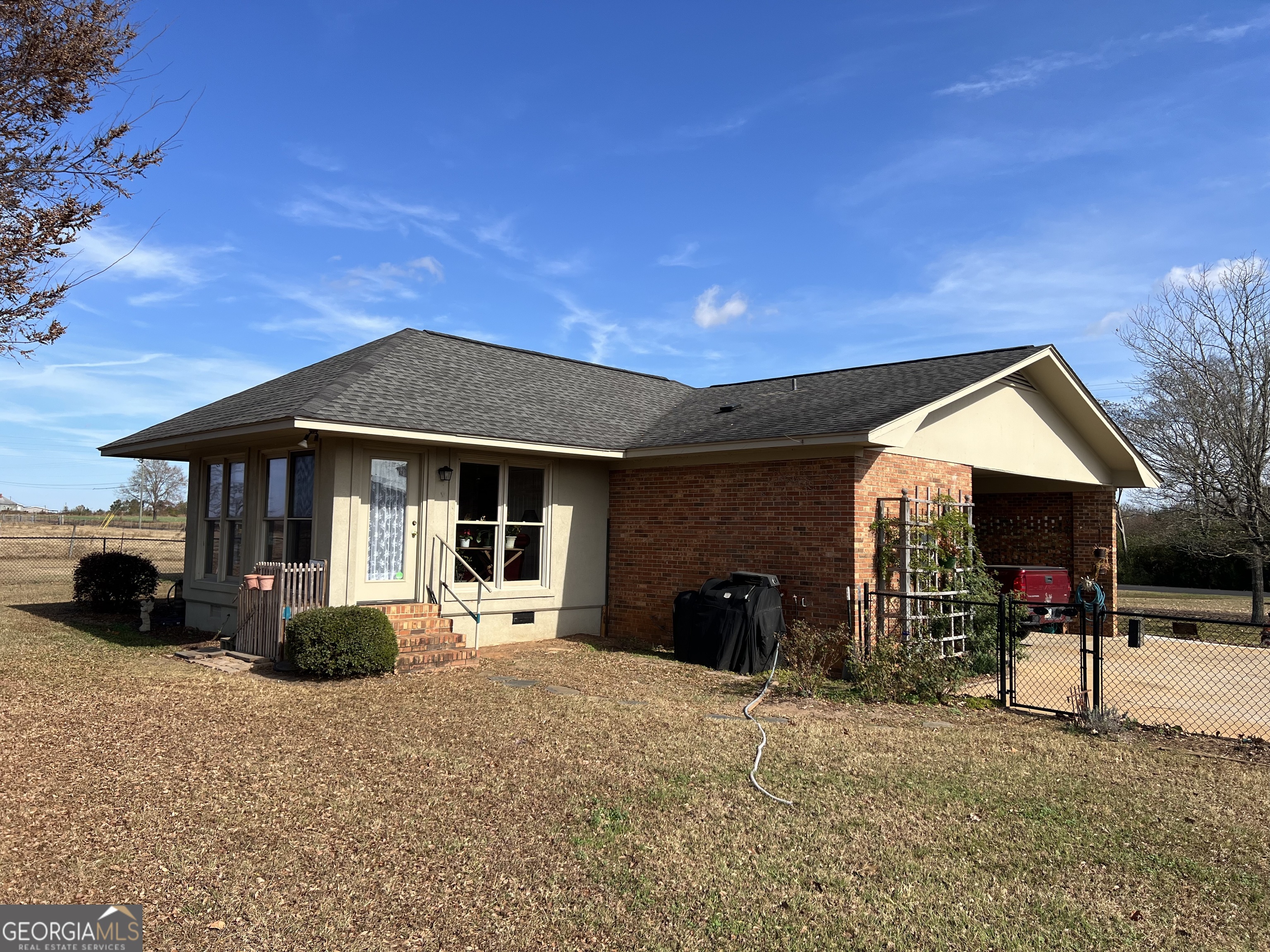 1512 Buckeye Road East Dublin, GA 31027 - Photo 34 of 45 a view of a house with large space and a car park