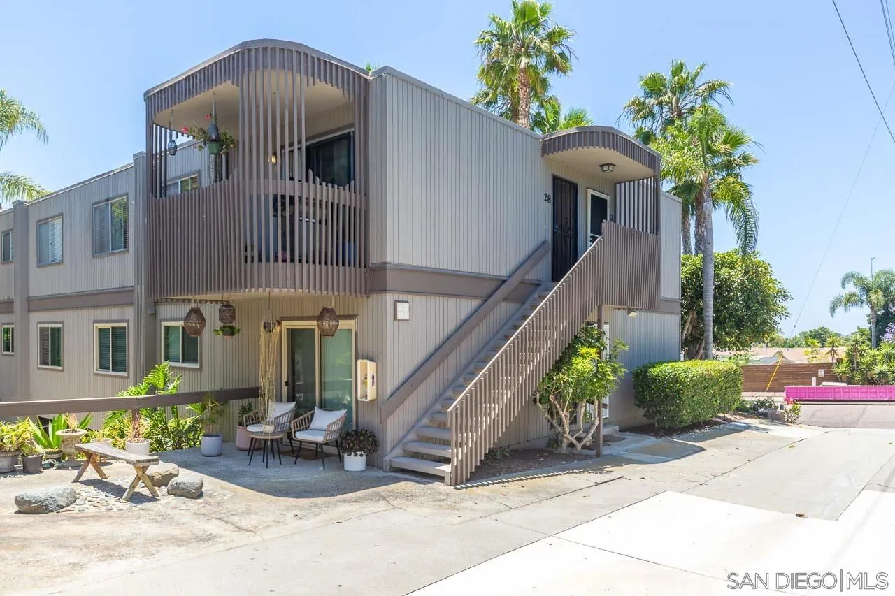 a front view of a house with outdoor seating and plants