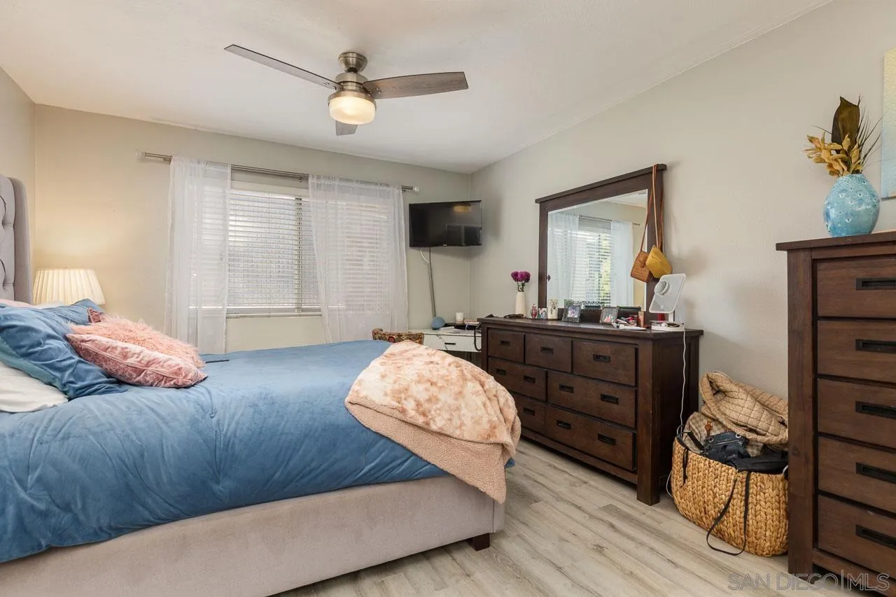 155 Rosebay Drive, Unit 28 Encinitas, CA 92024 - Photo 11 of 23 a bedroom with a bed and a dresser