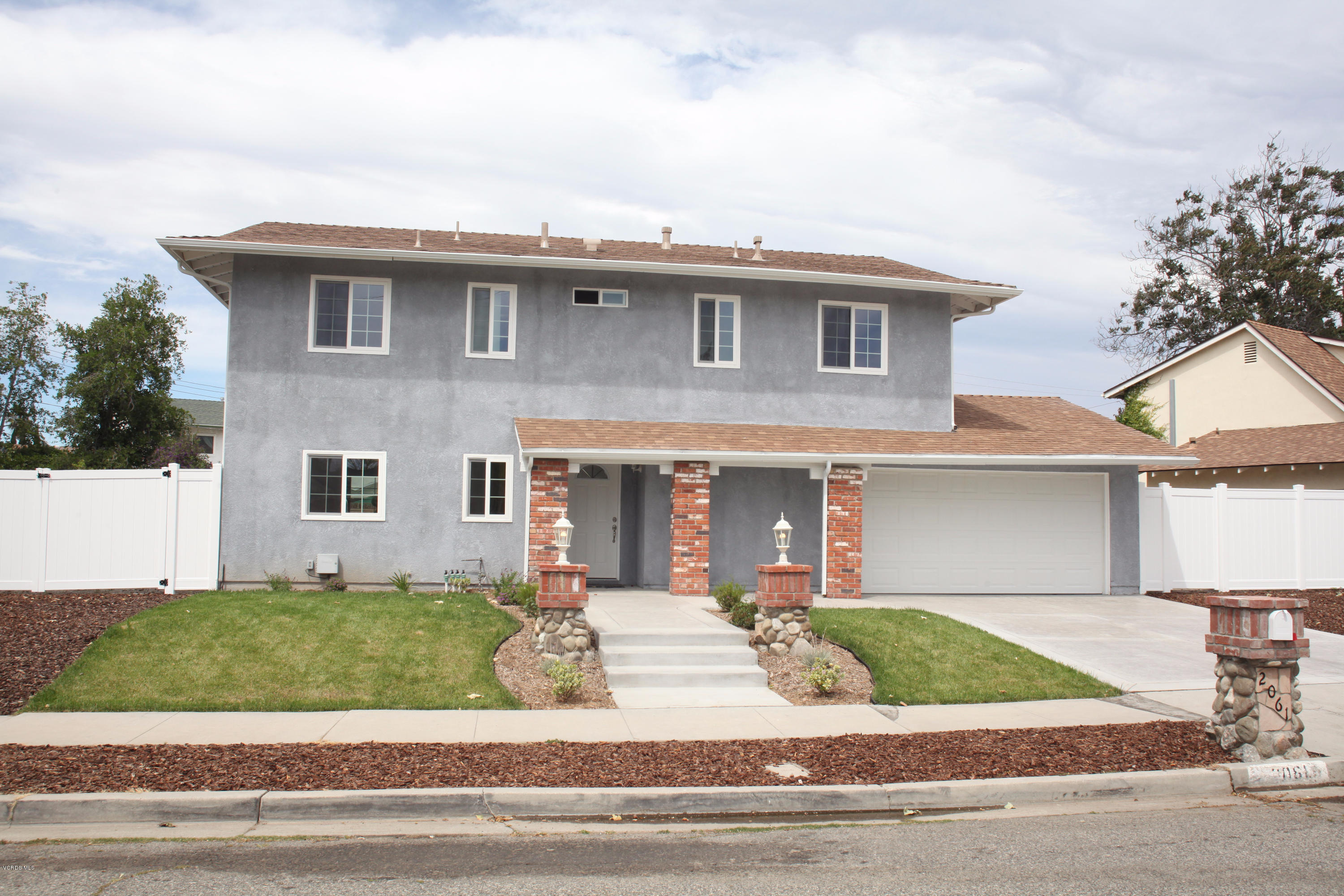 2061 Rhoda Street Simi Valley, CA 93065 - Photo 1 of 27 a front view of a house with a garden