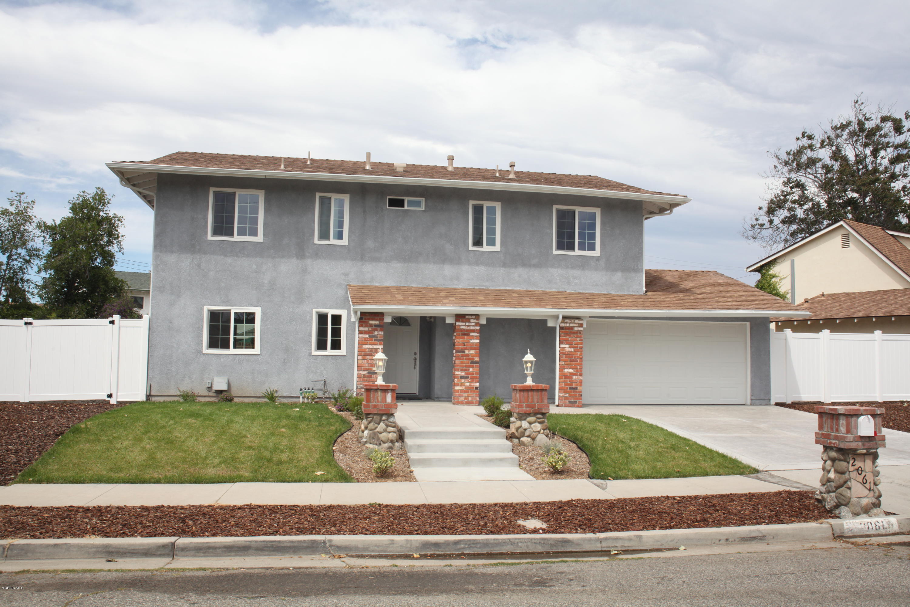 2061 Rhoda Street Simi Valley, CA 93065 - Photo 2 of 27 a front view of a house with a garden