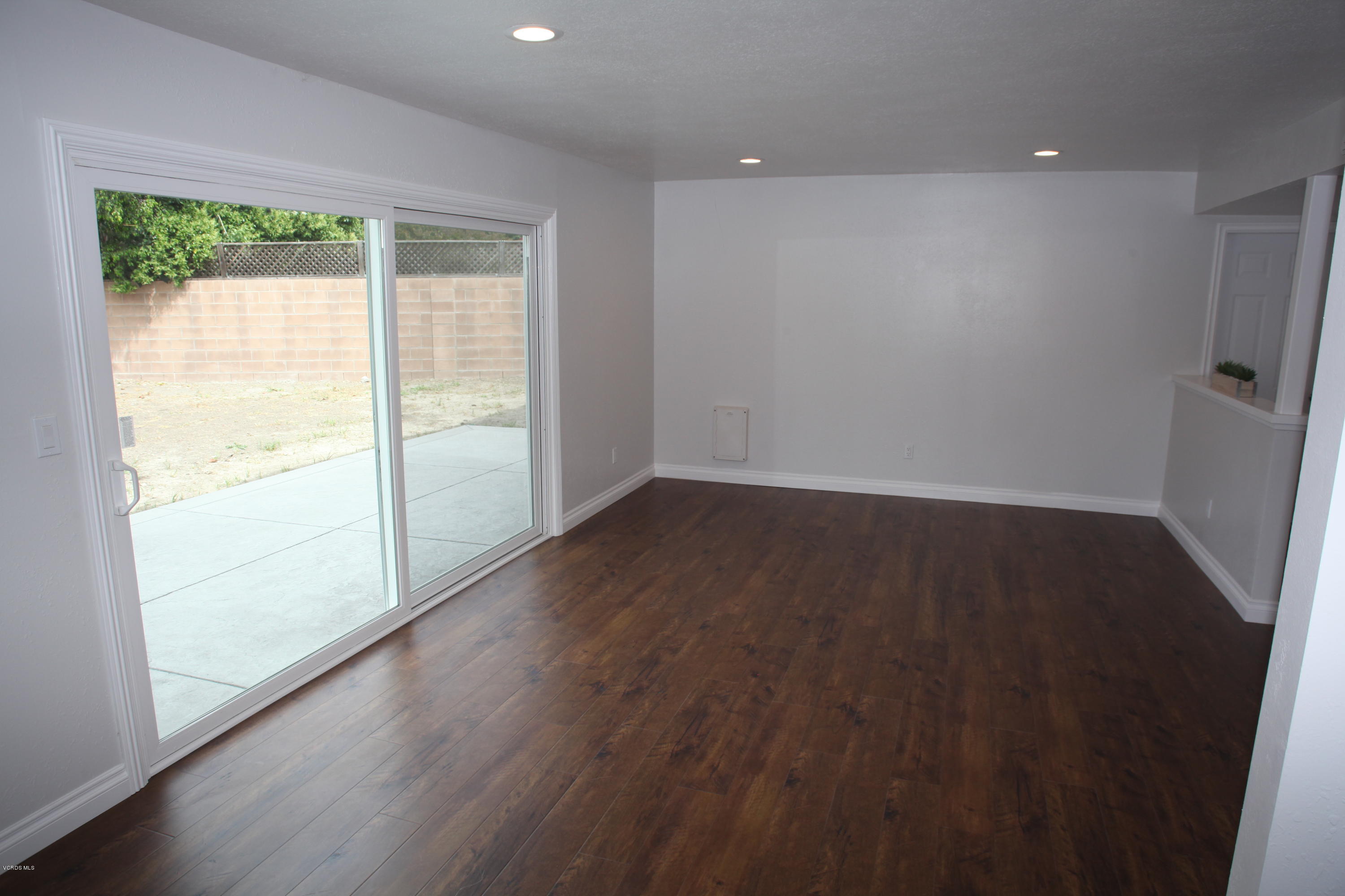 2061 Rhoda Street Simi Valley, CA 93065 - Photo 6 of 27 an empty room with wooden floor and windows