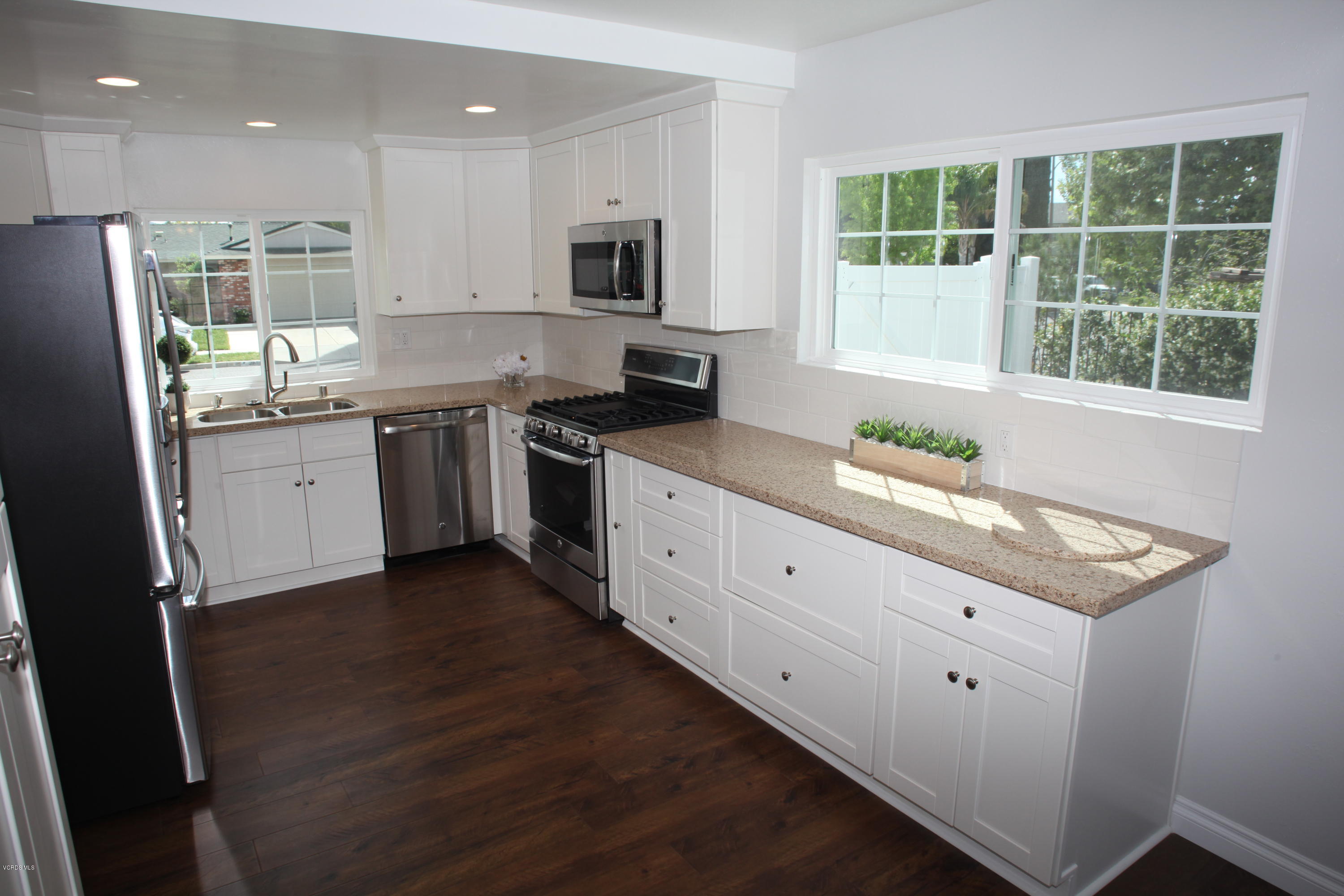 2061 Rhoda Street Simi Valley, CA 93065 - Photo 9 of 27 a kitchen with granite countertop white cabinets and a wooden floor