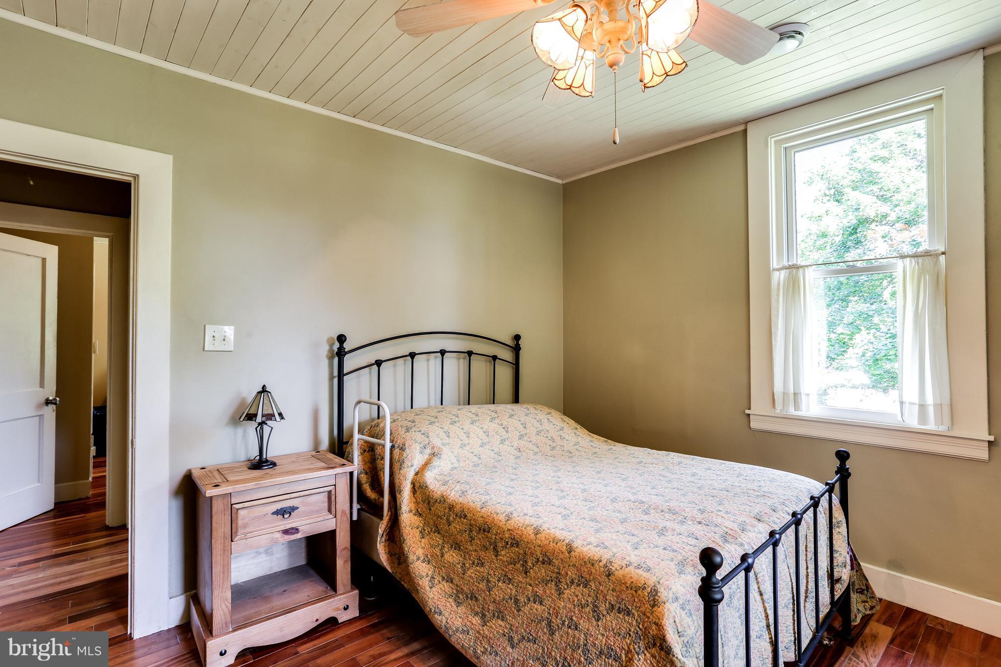 100 Hillside Road Baltimore, MD 21228 - Photo 20 of 30 a bedroom with a bed and a chandelier