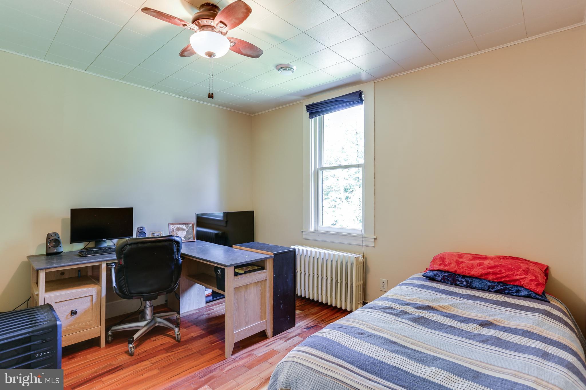 100 Hillside Road Baltimore, MD 21228 - Photo 24 of 30 a bedroom with a bed and a window