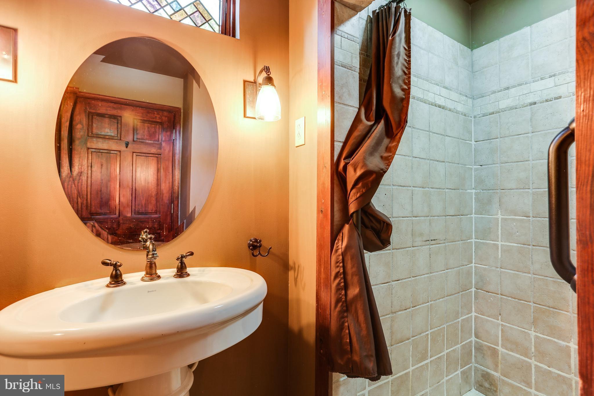 100 Hillside Road Baltimore, MD 21228 - Photo 5 of 30 a bathroom with a sink a mirror and vanity