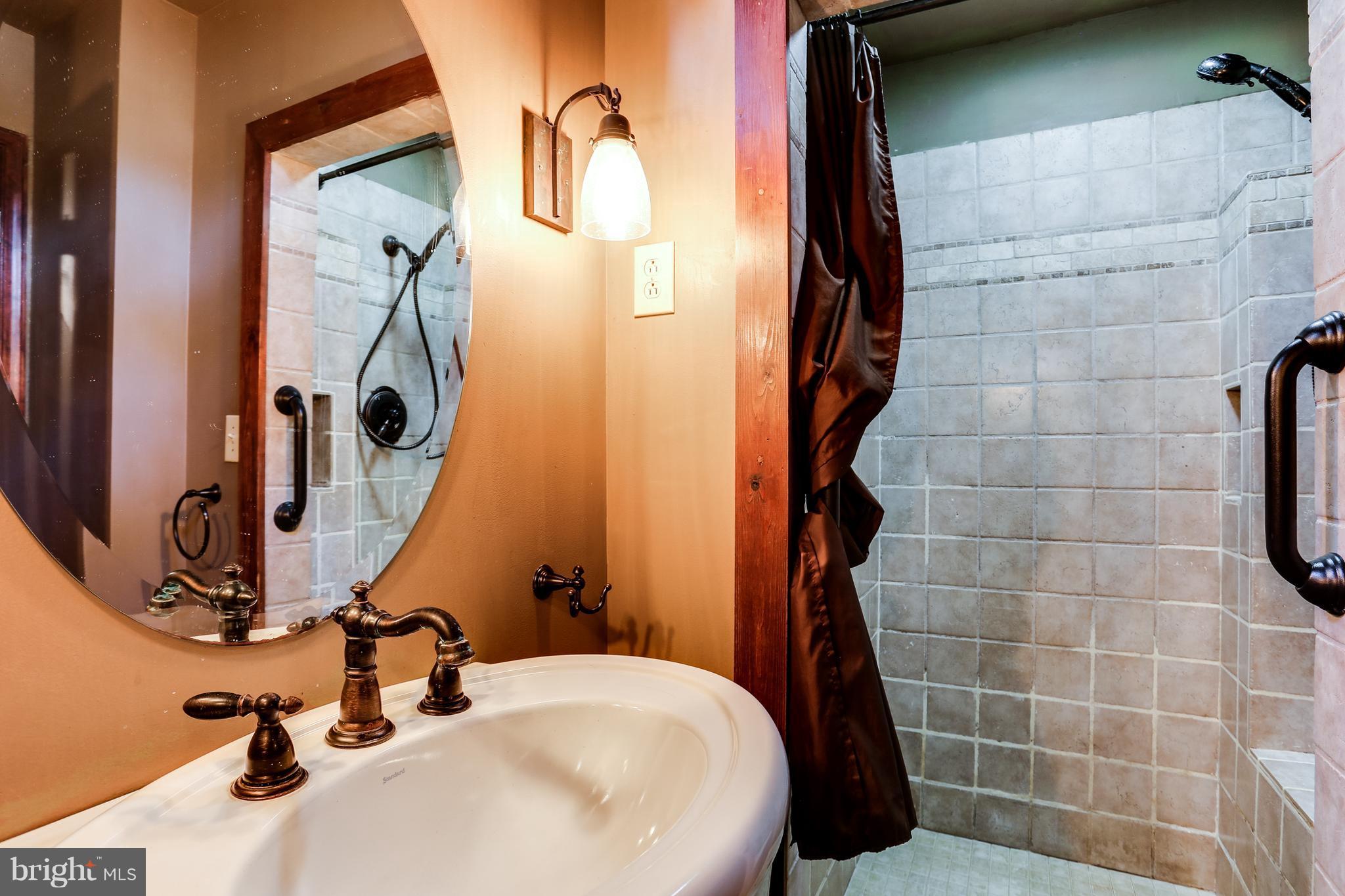 100 Hillside Road Baltimore, MD 21228 - Photo 6 of 30 a bathroom with a sink and mirror