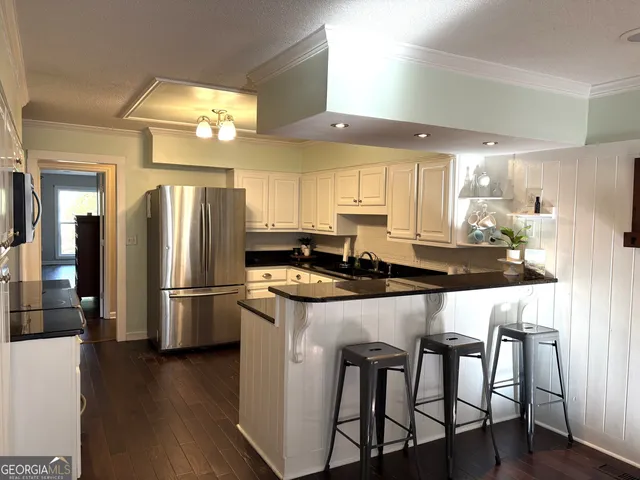 a kitchen with a refrigerator stove and microwave