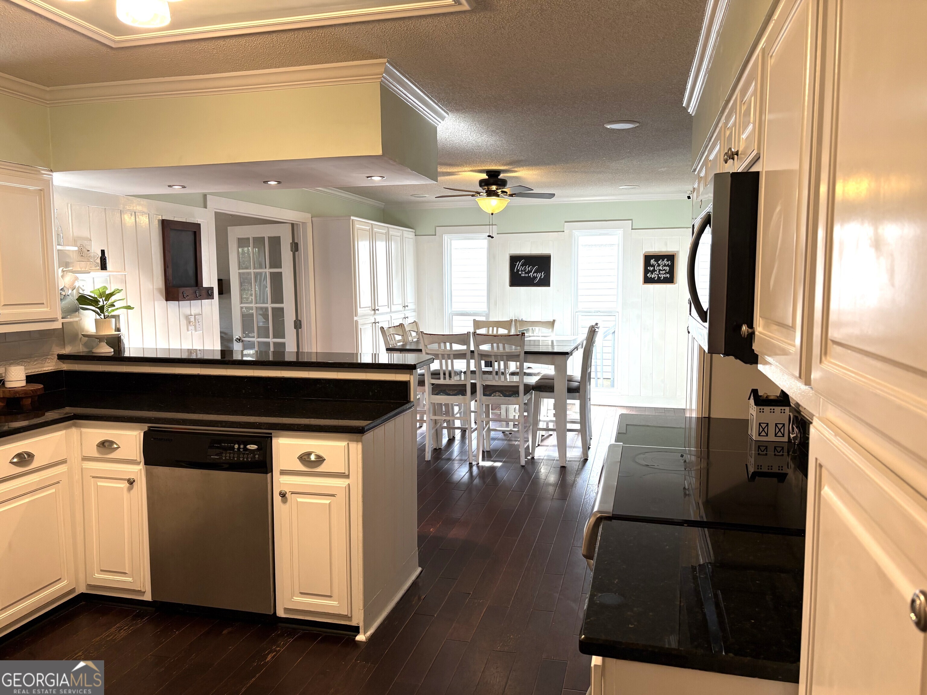 502 Payne Place Dublin, GA 31021 - Photo 16 of 61 a kitchen with stainless steel appliances granite countertop a stove and white cabinets