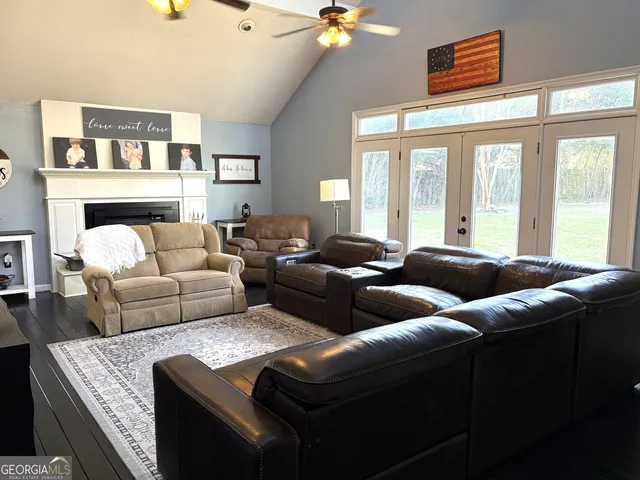 a living room with furniture a fireplace and a flat screen tv