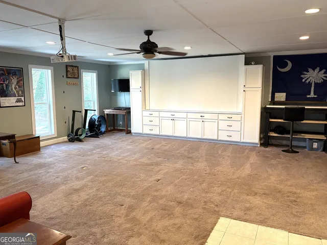 a view of a livingroom with furniture and a ceiling fan