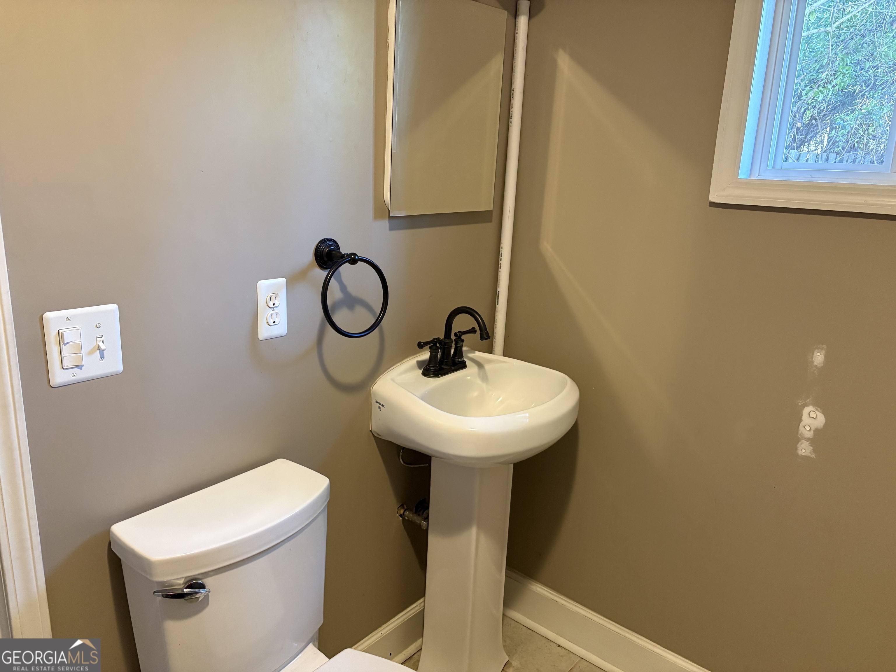 502 Payne Place Dublin, GA 31021 - Photo 26 of 61 a bathroom with a sink mirror and toilet