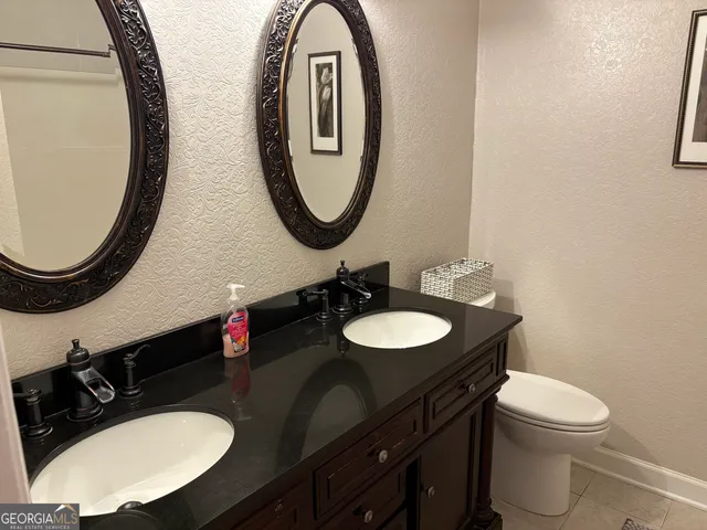 a bathroom with double sink and a mirror