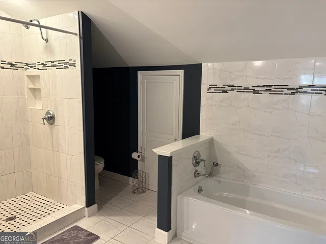 a front view of house with yard and trees in the background