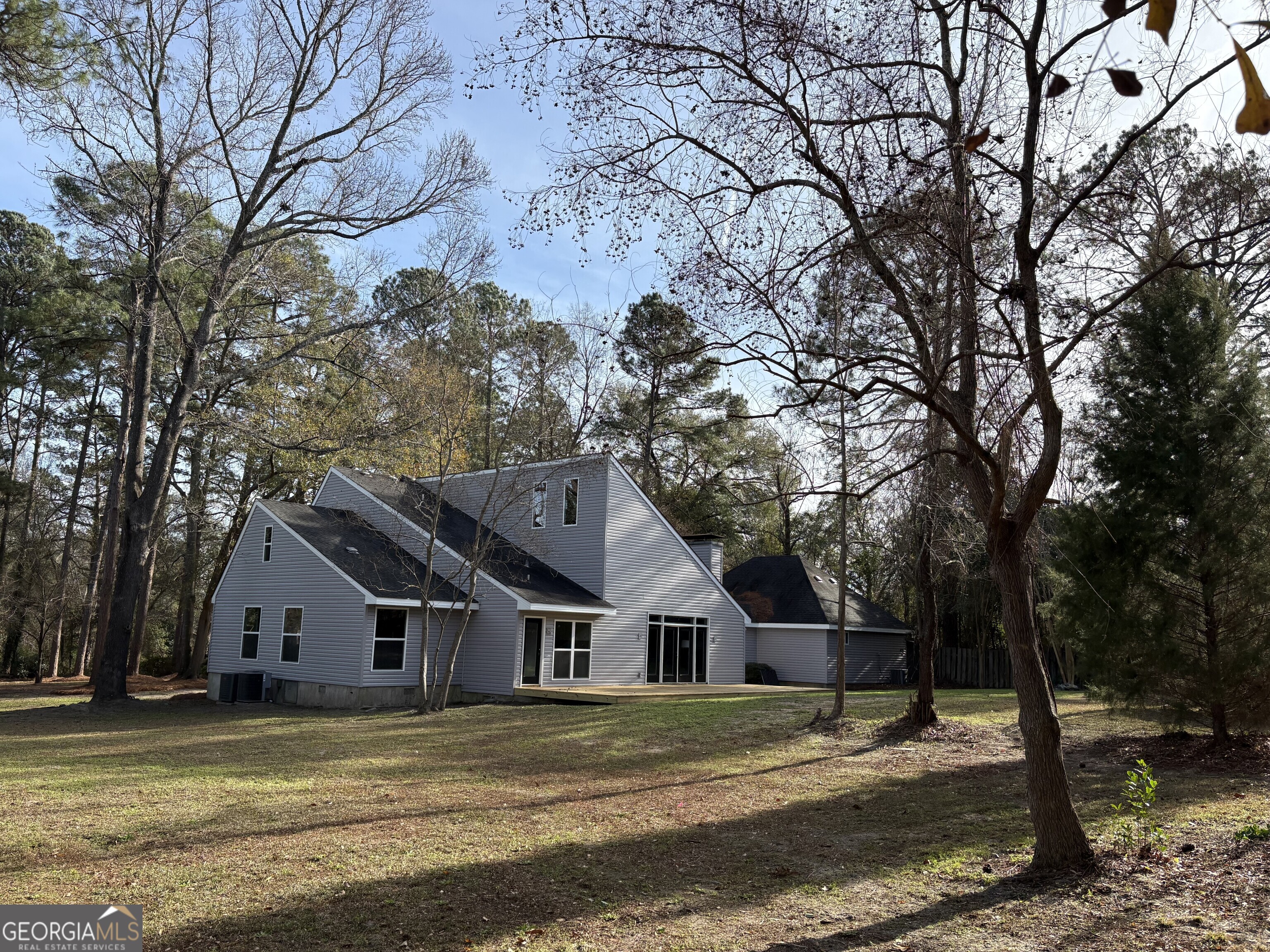 502 Payne Place Dublin, GA 31021 - Photo 54 of 61 a front view of a house with a yard and large trees
