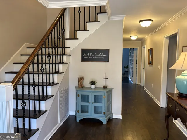 a view of a hallway and wooden floor