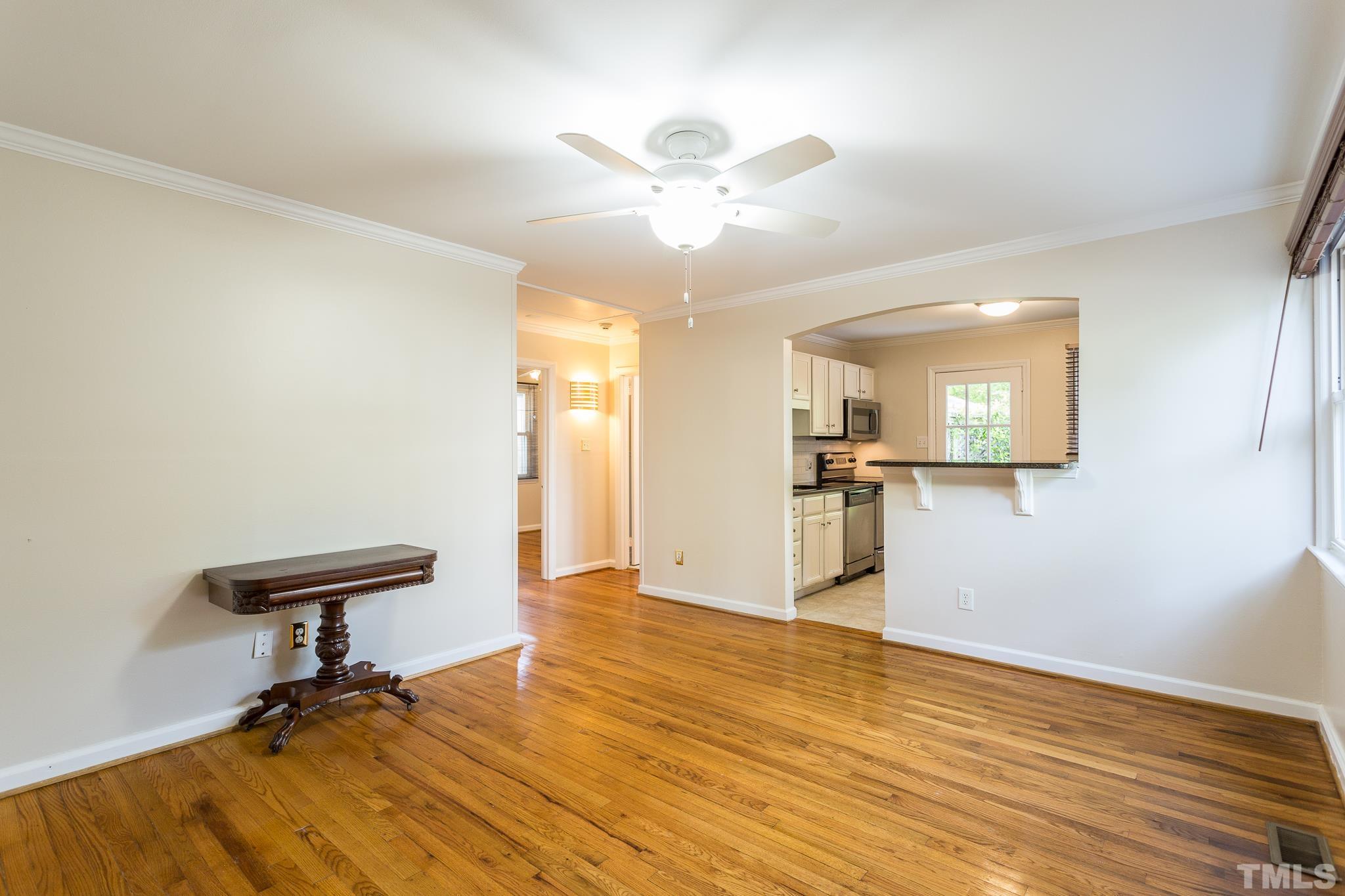 2211 Bernard Street, Unit 2211 Raleigh, NC 27608 - Photo 3 of 15 a view of a livingroom with a piano and wooden floor