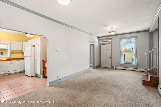 a view of empty room with a fireplace and window