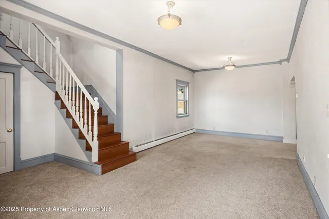 a view of an empty room with stairs