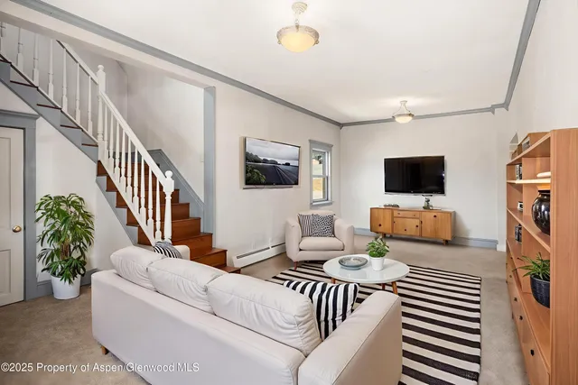a living room with furniture and a flat screen tv